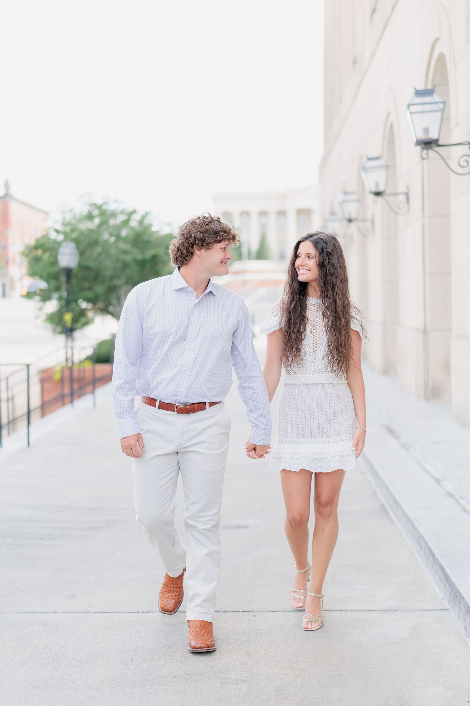 Authentic, joyful engagement portrait of a couple walking together taken by a photographer based in South Georgia.