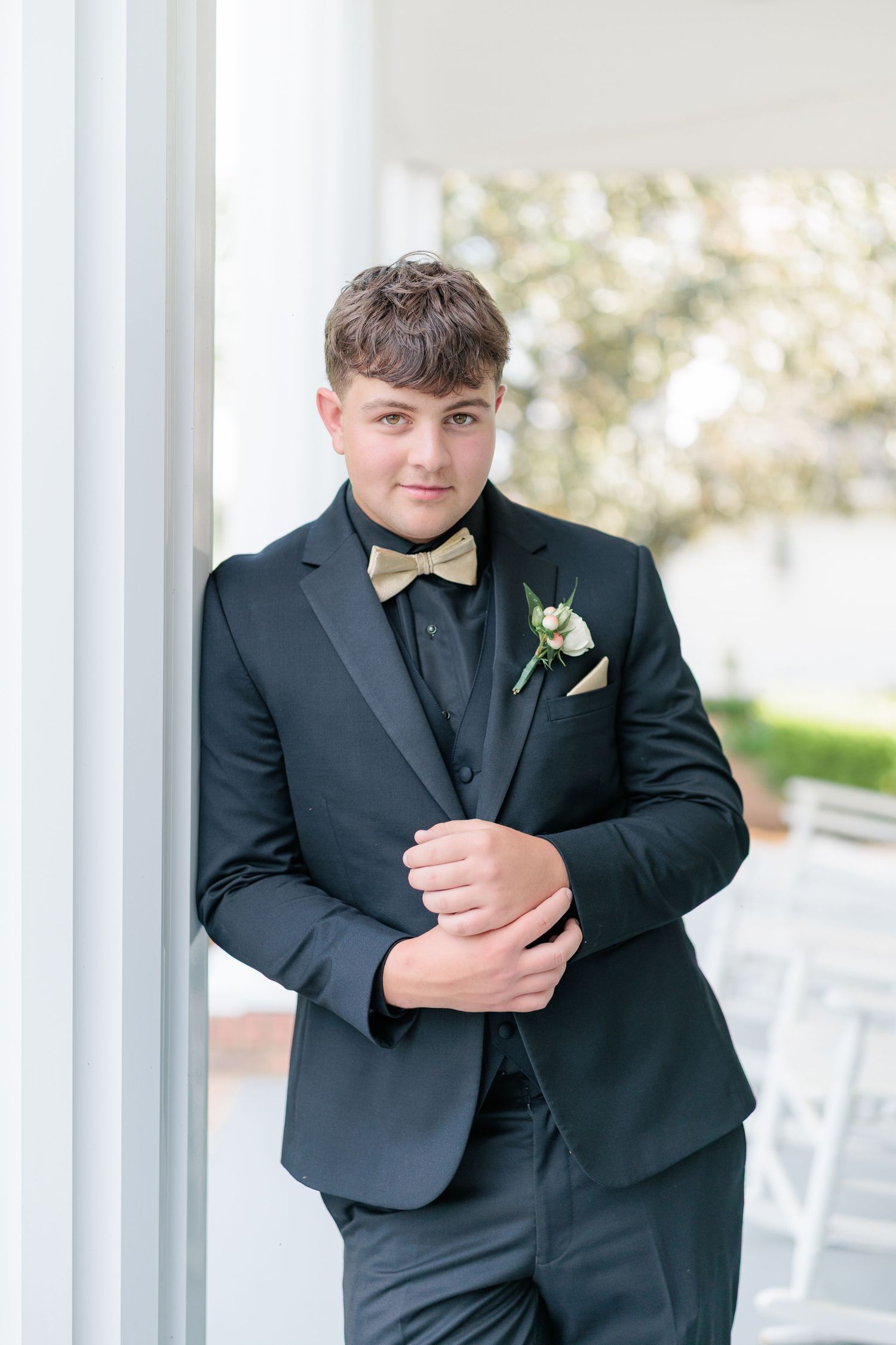 Sharp portrait of a high school guy dressed in a classic prom attire with a boutonniere, taken by a photographer based in Valdosta, GA.