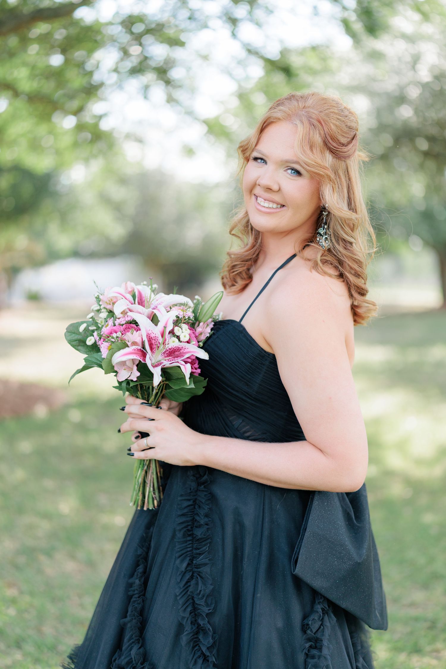 Beautiful portrait of a high school girl in her elegant prom dress holding a floral arrangement, taken by a photographer in Valdosta, GA.