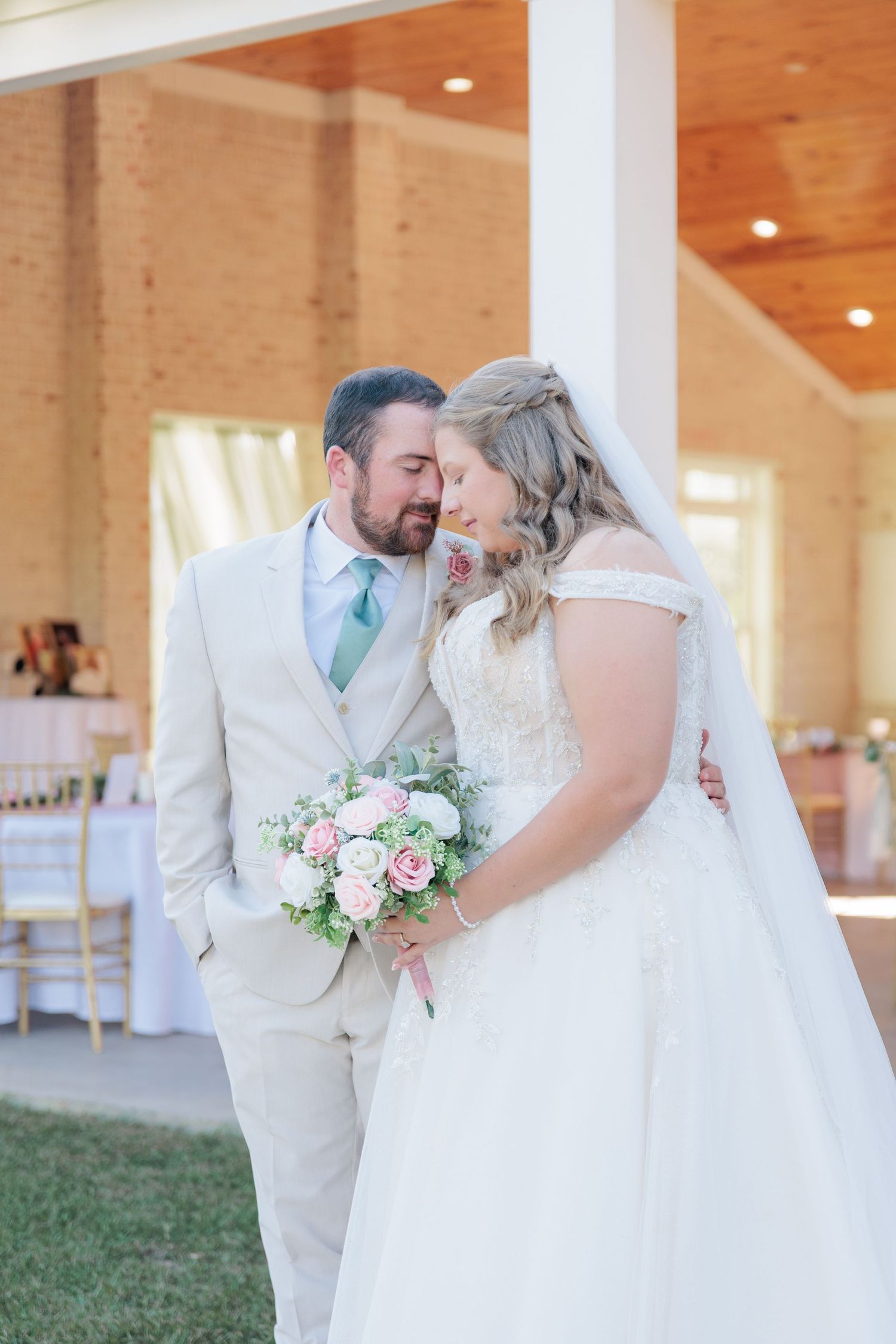 Candid portrait of a bride and groom embracing during a romantic couple's portrait session during their wedding day in South Georgia.