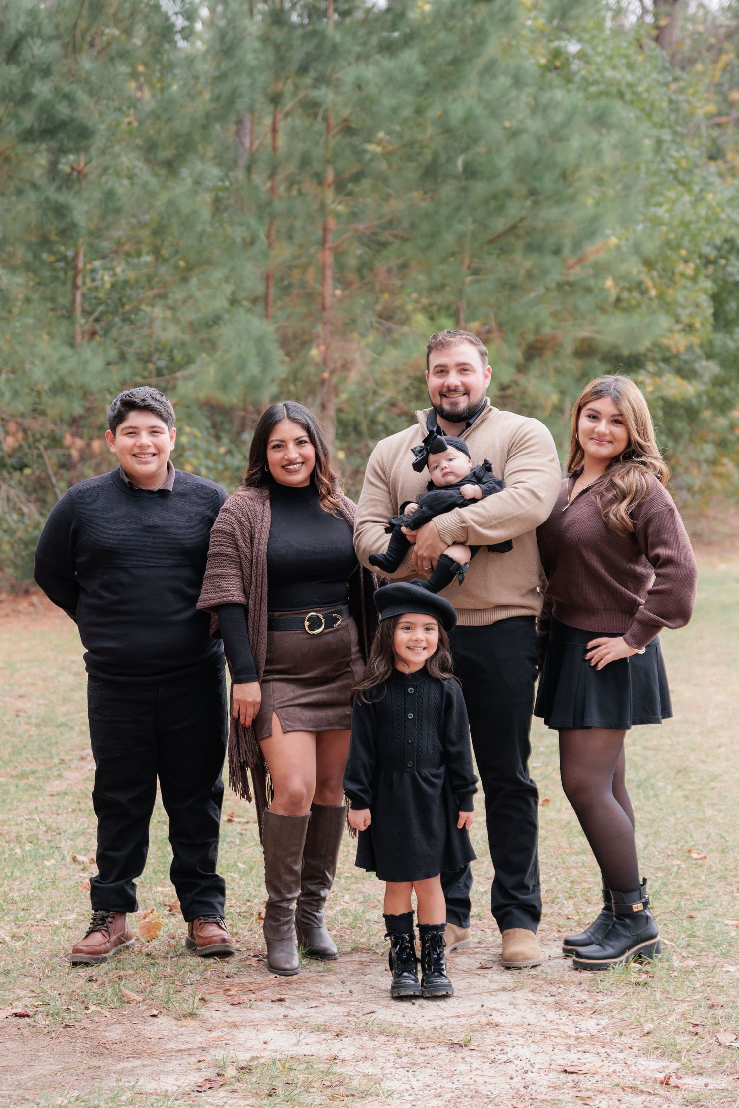 Candid, natural family portrait session featuring parents and children laughing together outdoors in South Georgia.