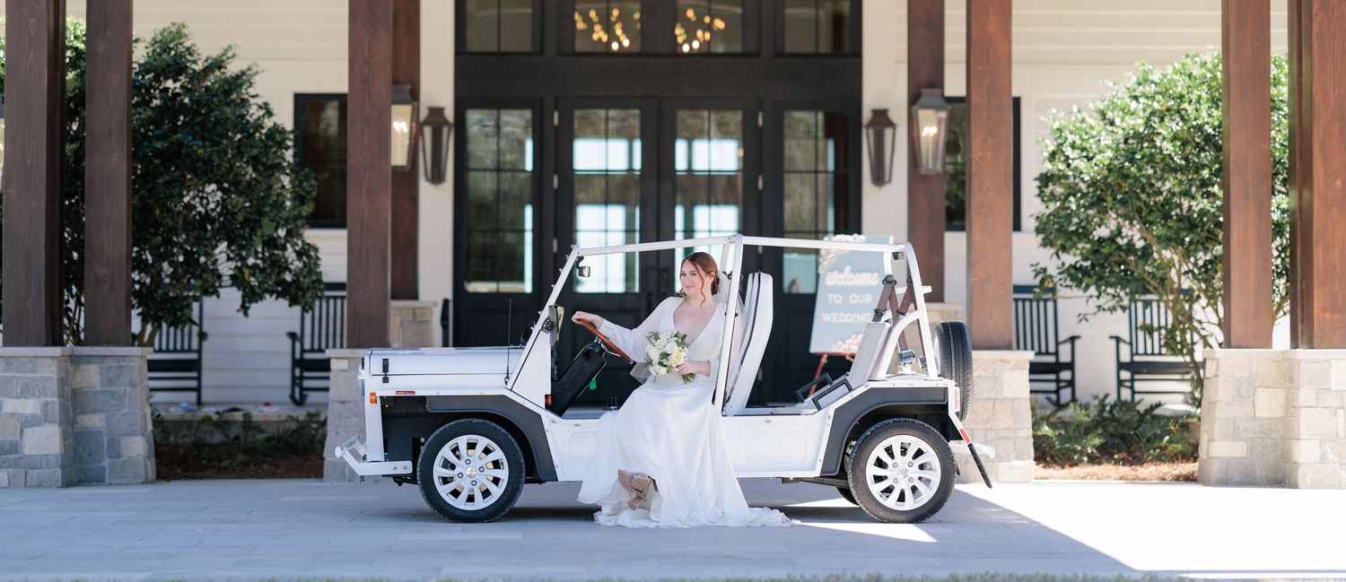 Bride posing in the getaway vehicle as she waits for her groom. Taken by a photographer based in Valdosta, Georgia.