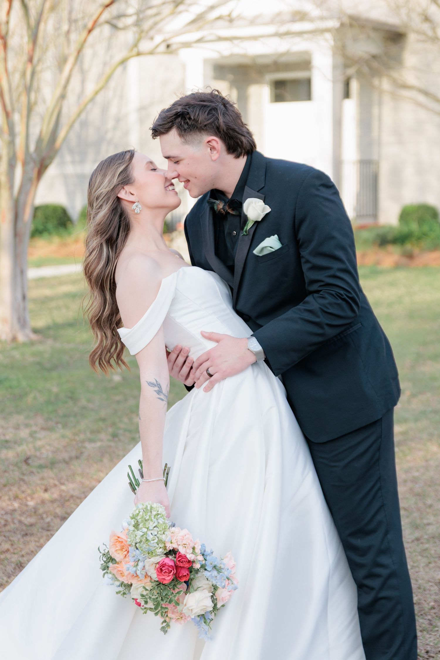 Portrait of a bride and groom embracing during a romantic couple's session during their wedding day in South Georgia.