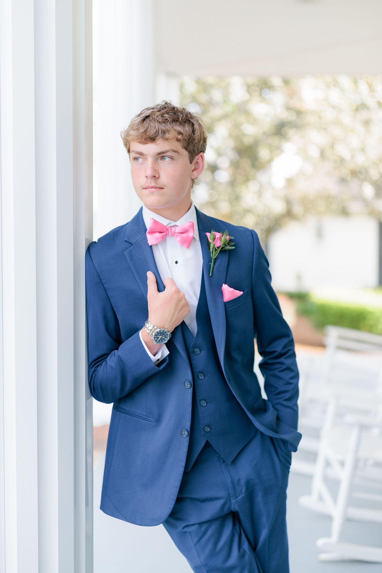 Sharp portrait of a high school guy dressed in a classic prom attire with a boutonniere, taken by a photographer based in Valdosta, GA.