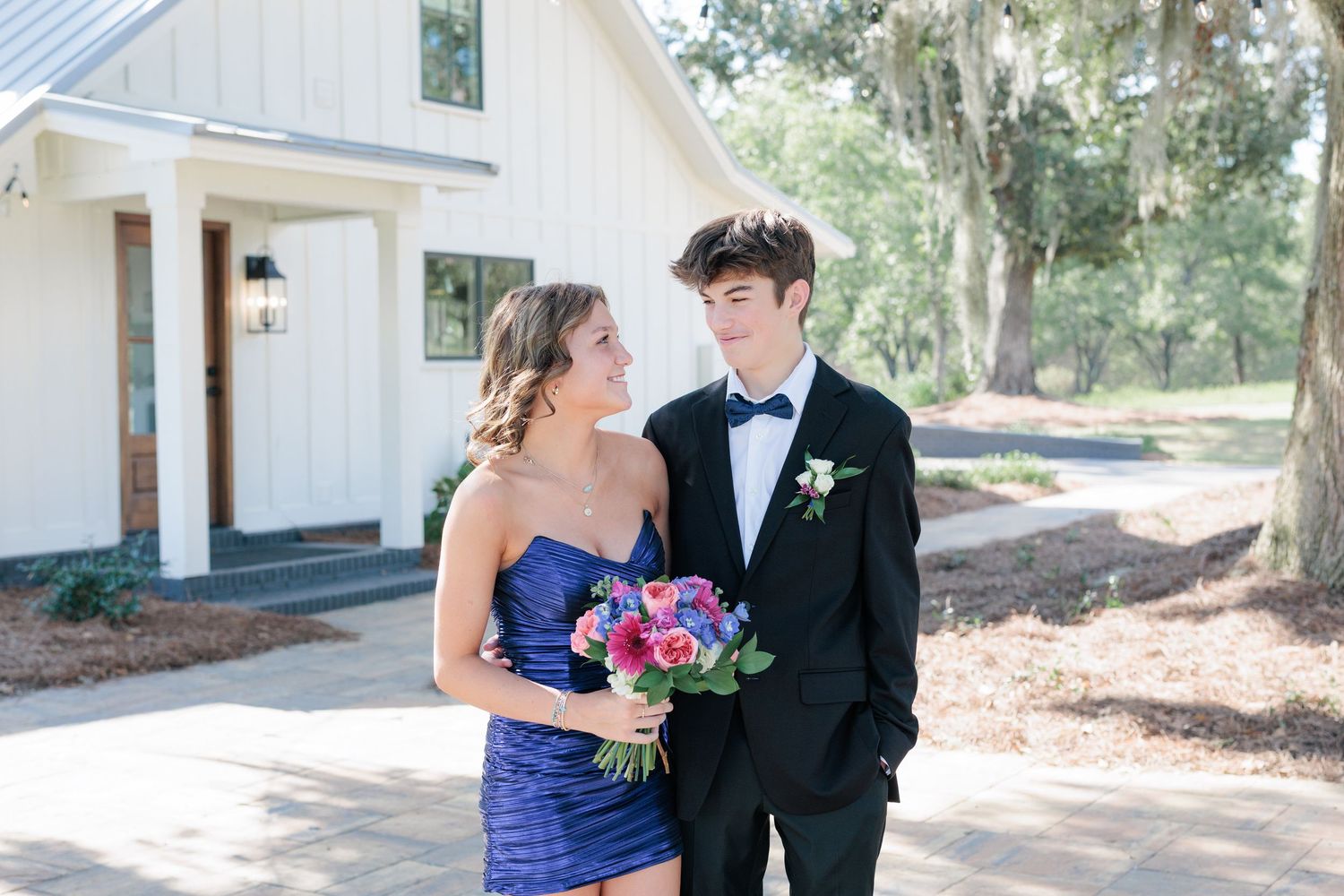 Elegant prom couple portrait of high school students dressed up in formalwear before the dance in Valdosta, Georgia.