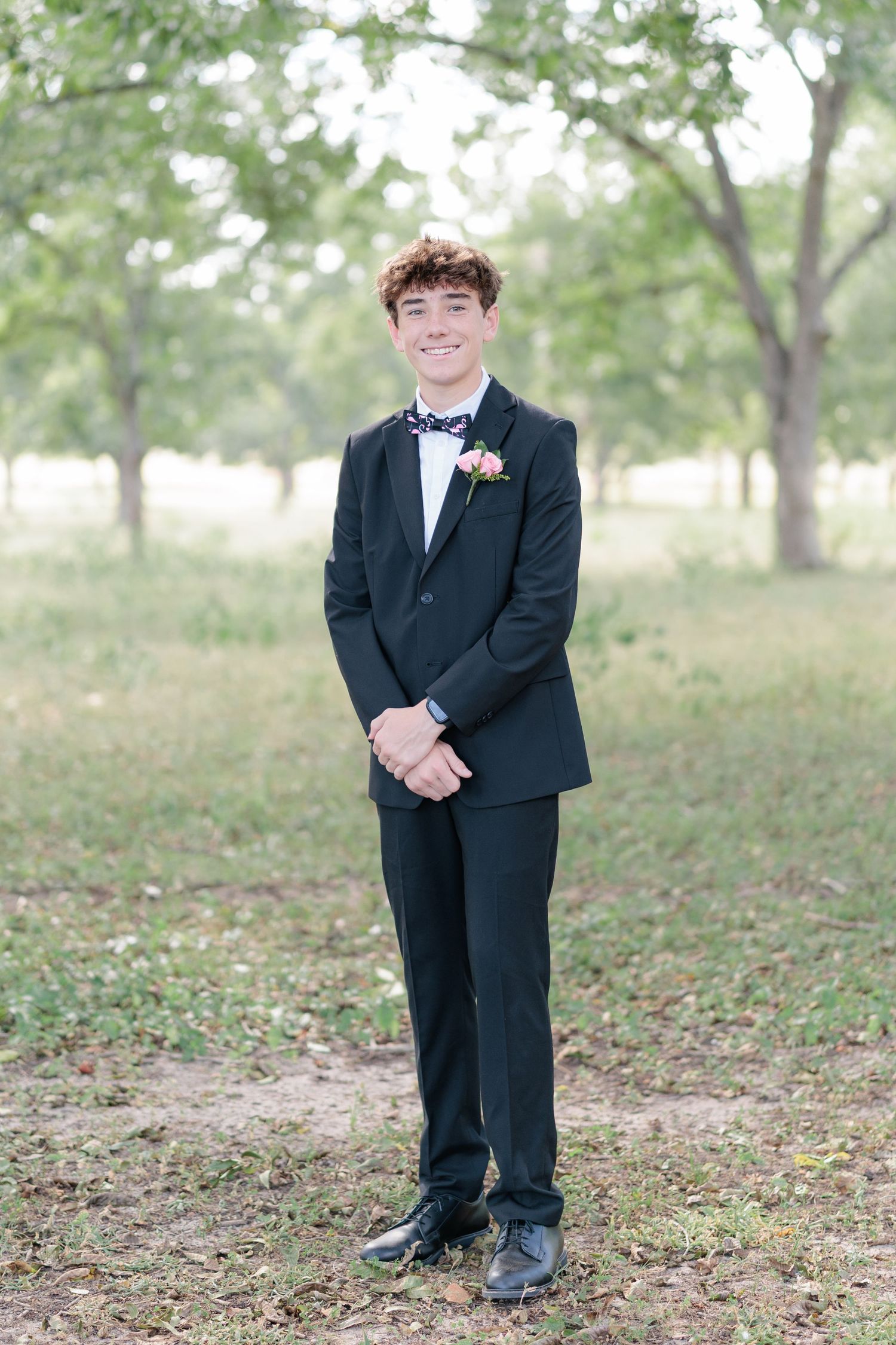 Sharp portrait of a high school guy dressed in a classic prom attire with a boutonniere, taken by a photographer based in Valdosta, GA.