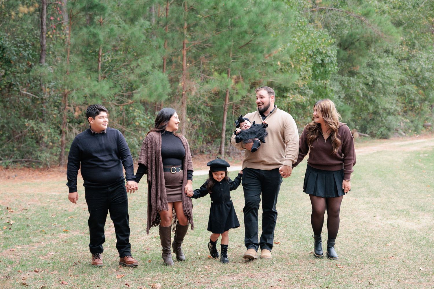 Candid, natural family portrait session featuring parents and children laughing together outdoors in South Georgia.