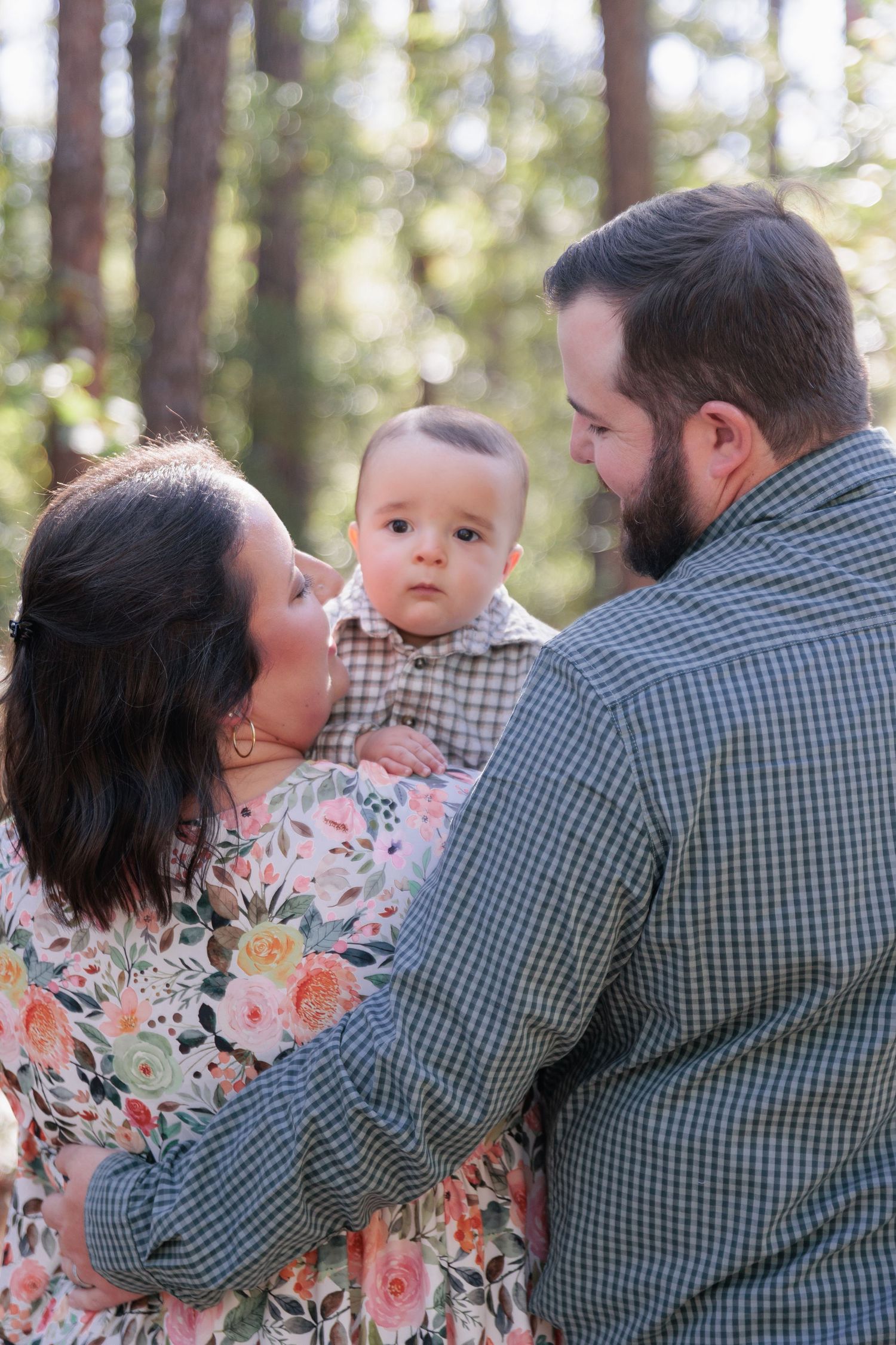 Candid, natural family portrait session featuring parents and children laughing together outdoors in South Georgia.
