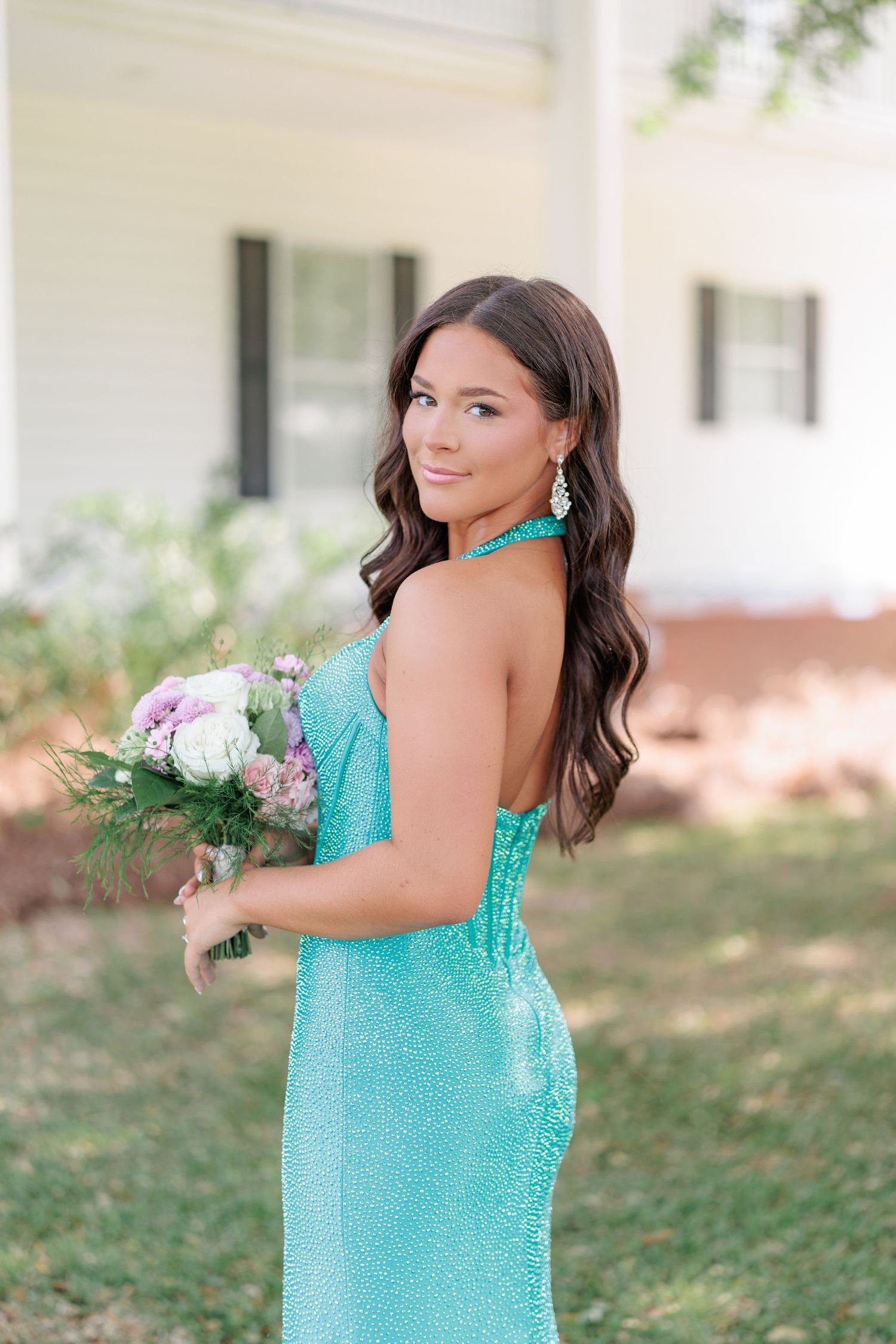 Prom student showing off dress and floral arrangement before attending prom. Taken by a photographer based in South Georgia.