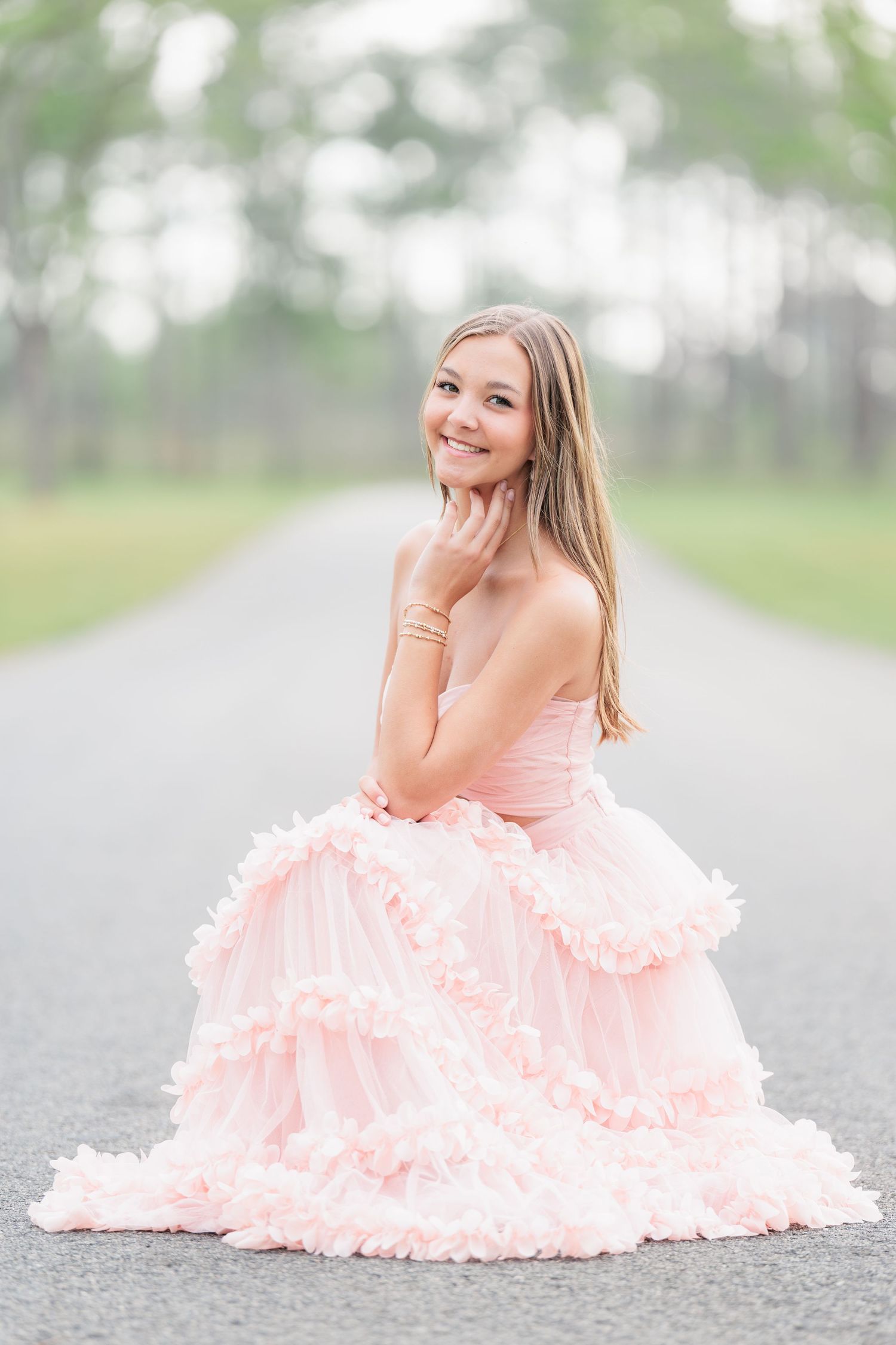 Elegant high school senior portrait of a girl in a beautiful dress at an outdoor park location in Valdosta, Georgia.