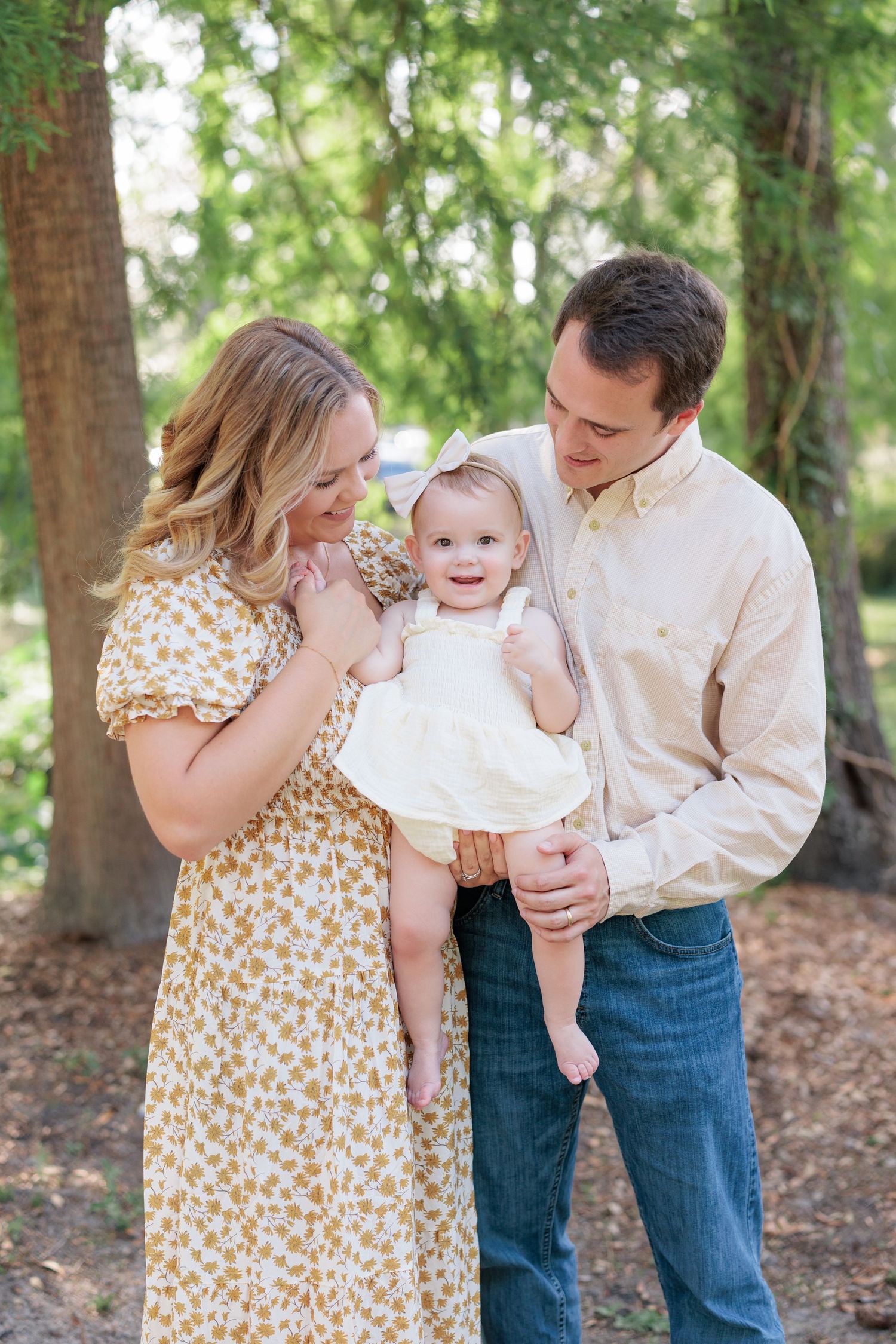 Candid, natural family portrait session featuring parents and children laughing together outdoors in South Georgia.