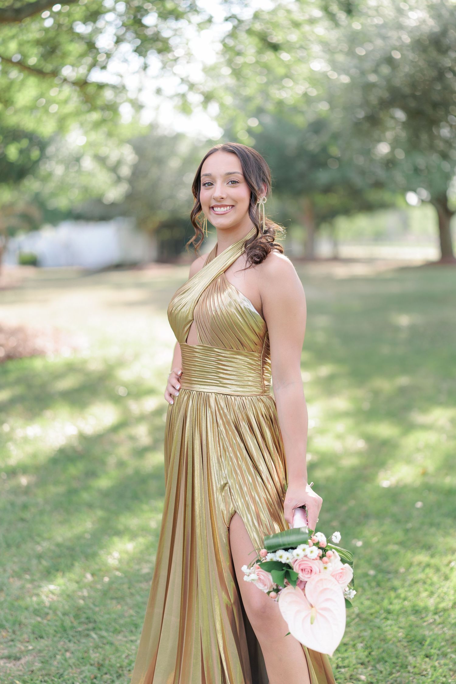 Beautiful portrait of a high school girl in her elegant prom dress holding a floral arrangement, taken by a photographer in Valdosta, GA.