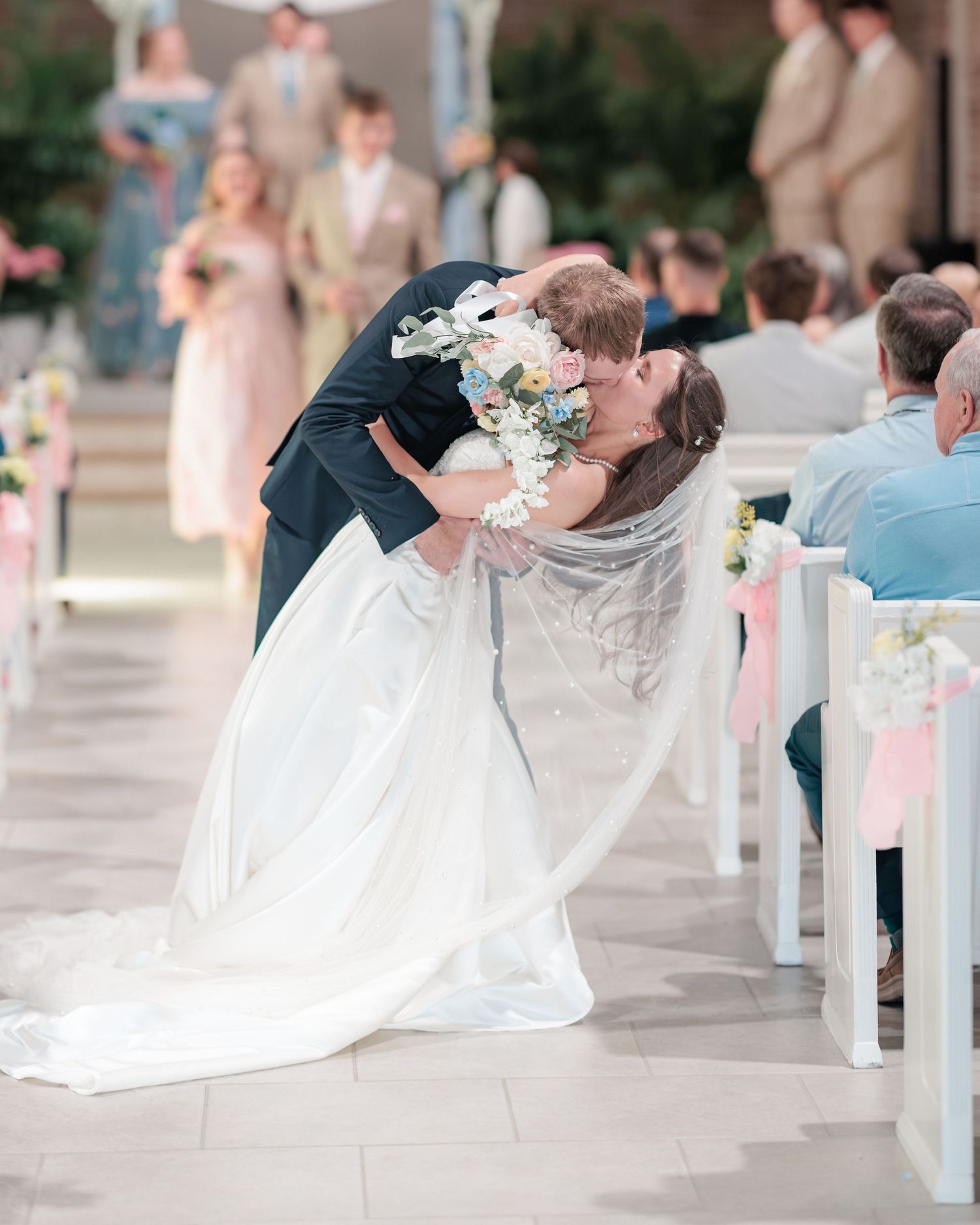 Portrait of a bride and groom embracing during their exit from the ceremony of their wedding day in South Georgia.
