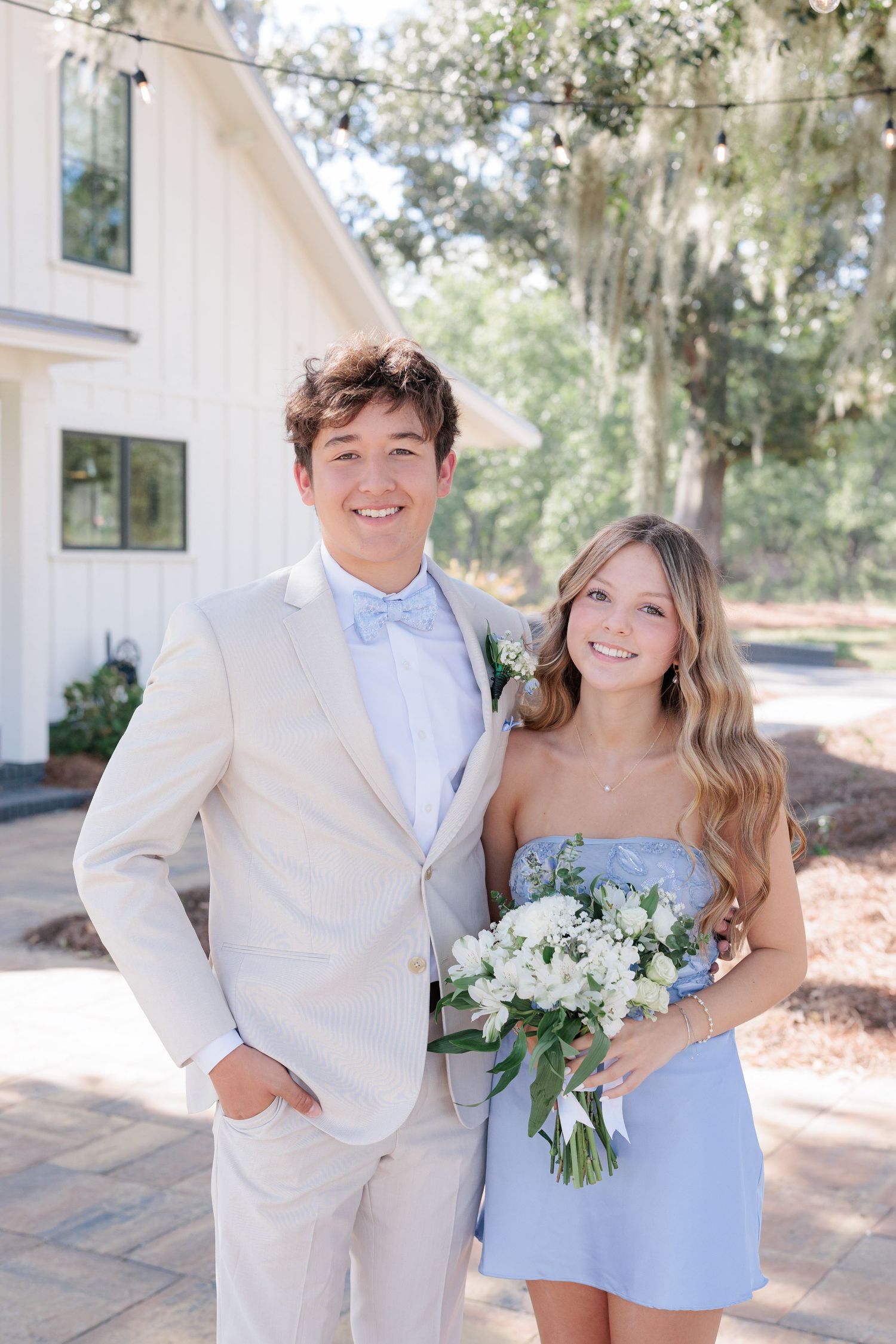 Elegant prom couple portrait of high school students dressed up in formalwear before the dance in Valdosta, Georgia.