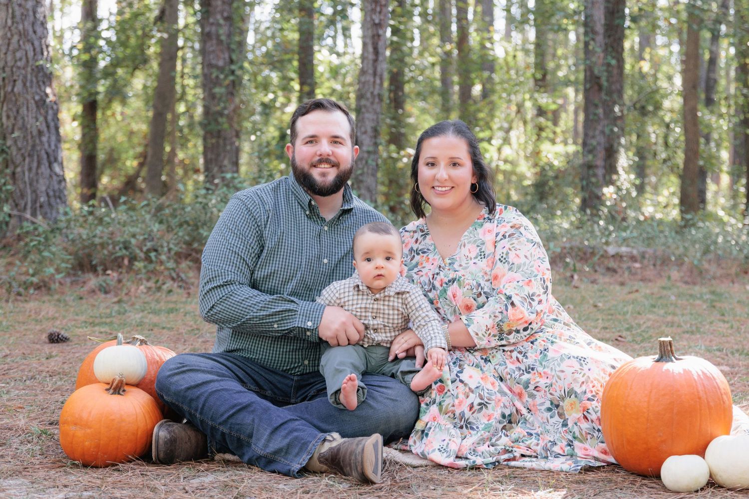 Candid, natural family portrait session featuring parents and children laughing together outdoors in South Georgia.