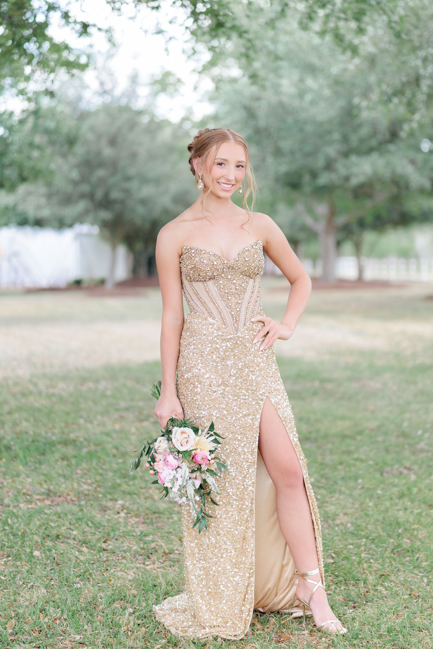 Beautiful portrait of a high school girl in her elegant prom dress holding a floral arrangement, taken by a photographer in Valdosta, GA.