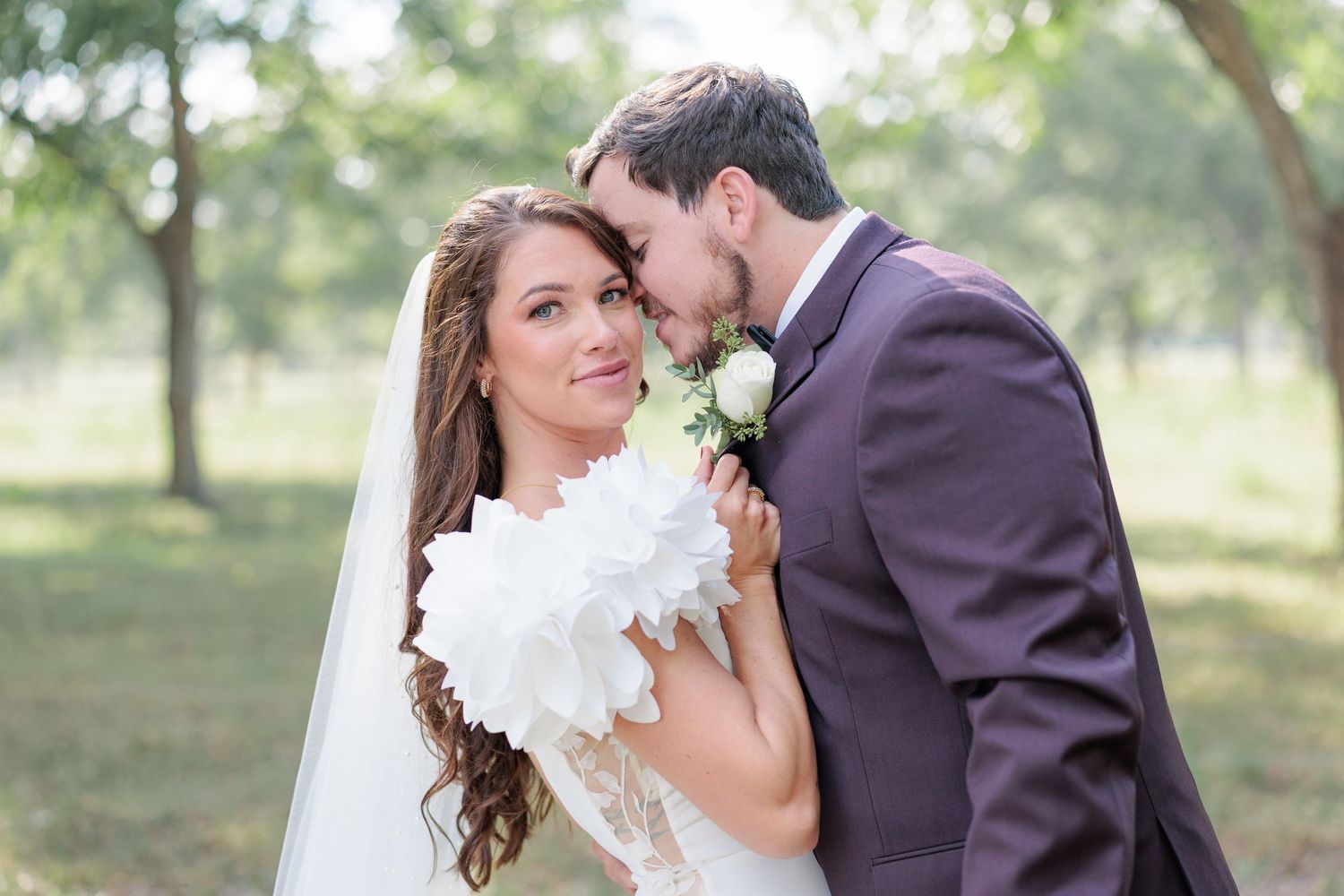 Portrait of a bride and groom embracing during a romantic couple's portrait session during their wedding day in South Georgia.