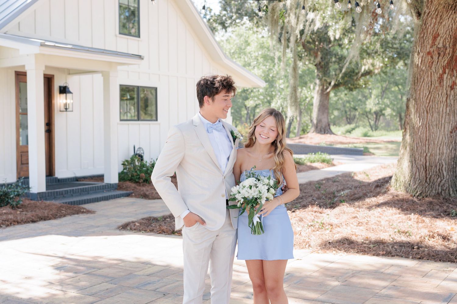 Elegant prom couple portrait of high school students dressed up in formalwear before the dance in Valdosta, Georgia.
