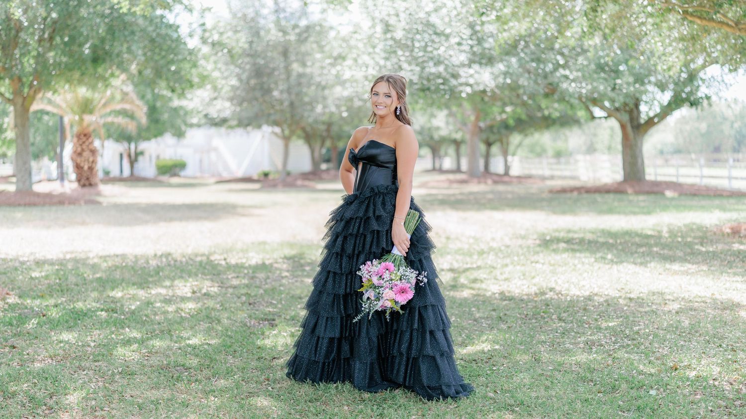 Beautiful portrait of a high school girl in her elegant prom dress holding a floral arrangement, taken by a photographer in Valdosta, GA.