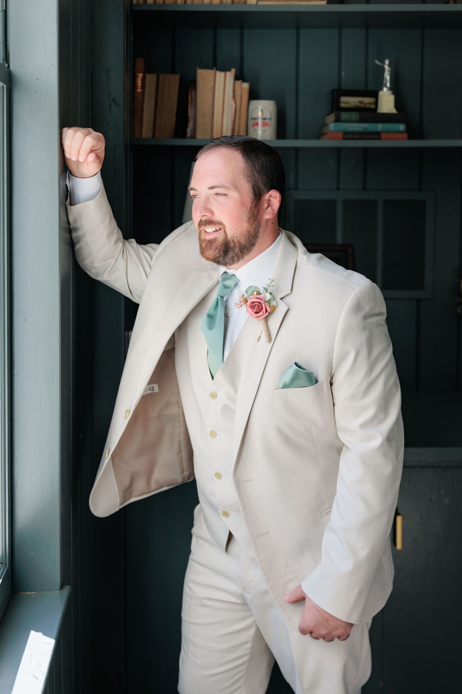 Sharp portrait of a groom adjusting his classic black tuxedo before a South Georgia wedding ceremony in Valdosta.