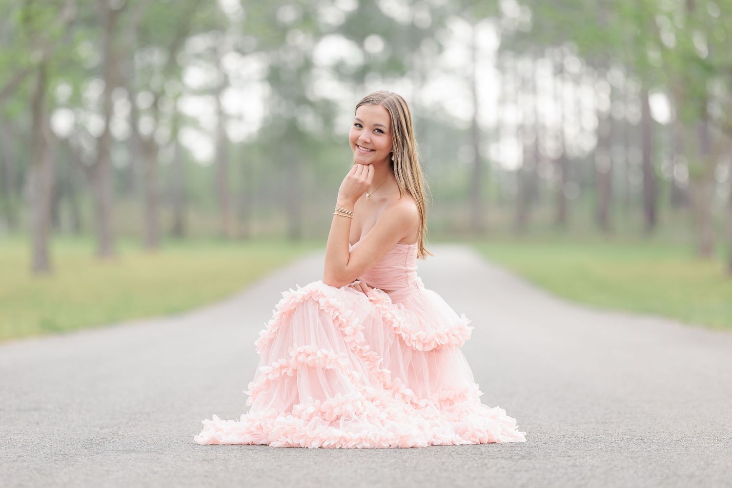 Elegant high school senior portrait of a girl in a beautiful dress at an outdoor park location in Valdosta, Georgia.
