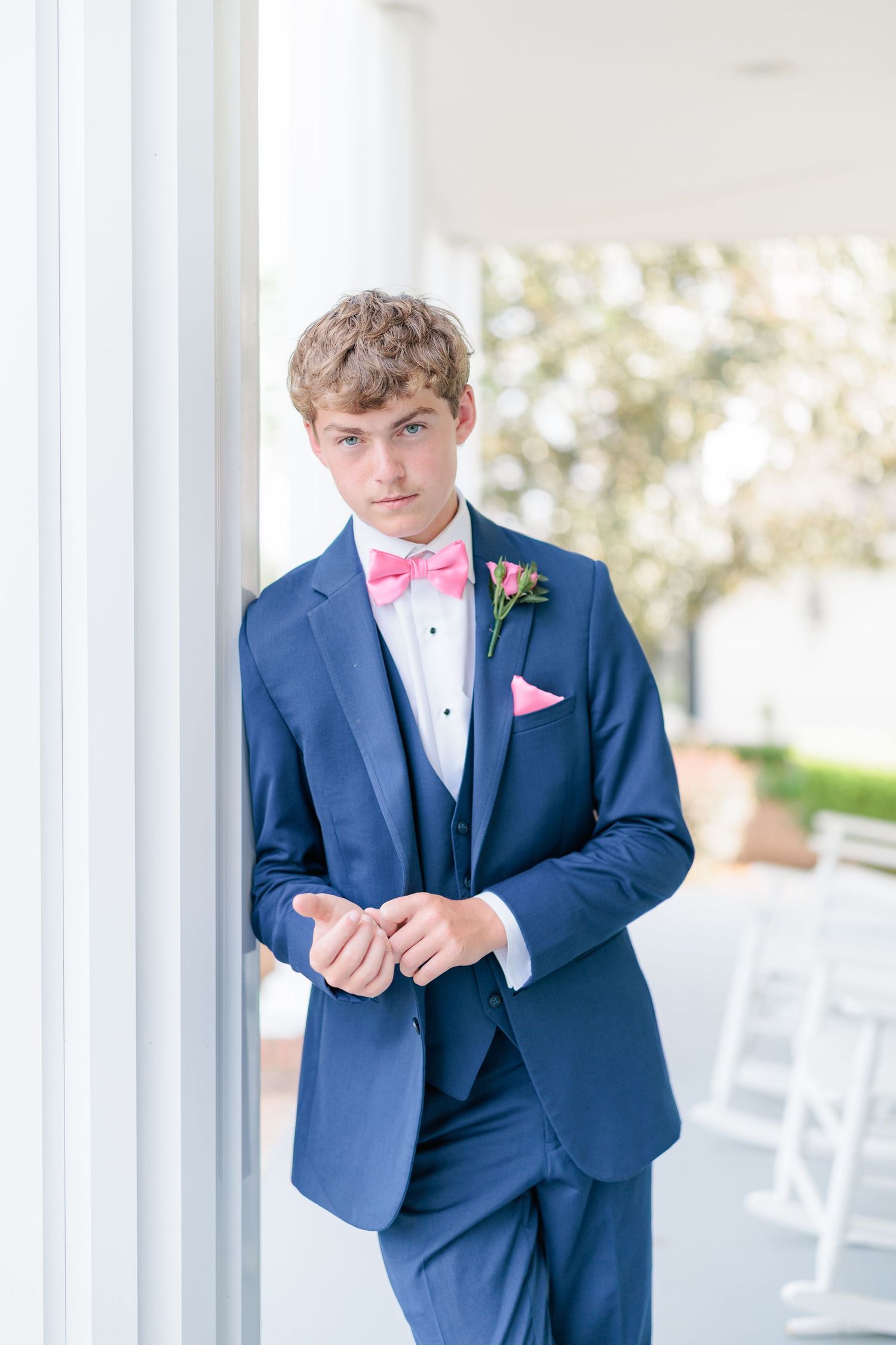 Sharp portrait of a high school guy dressed in a classic prom attire with a boutonniere, taken by a photographer based in Valdosta, GA.