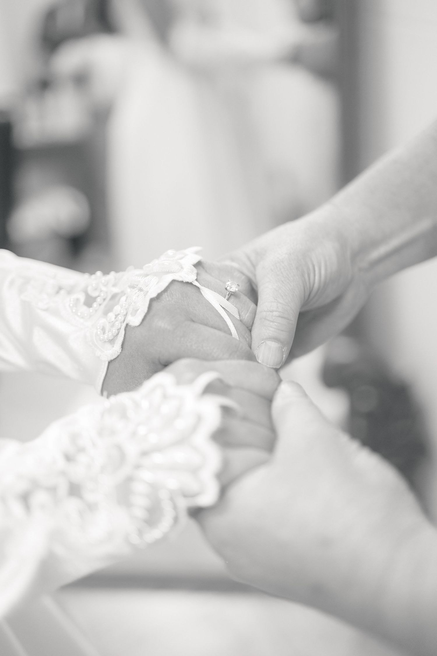 Bride and mother holding hands while getting ready for the ceremony to the bride's wedding in South Georgia.