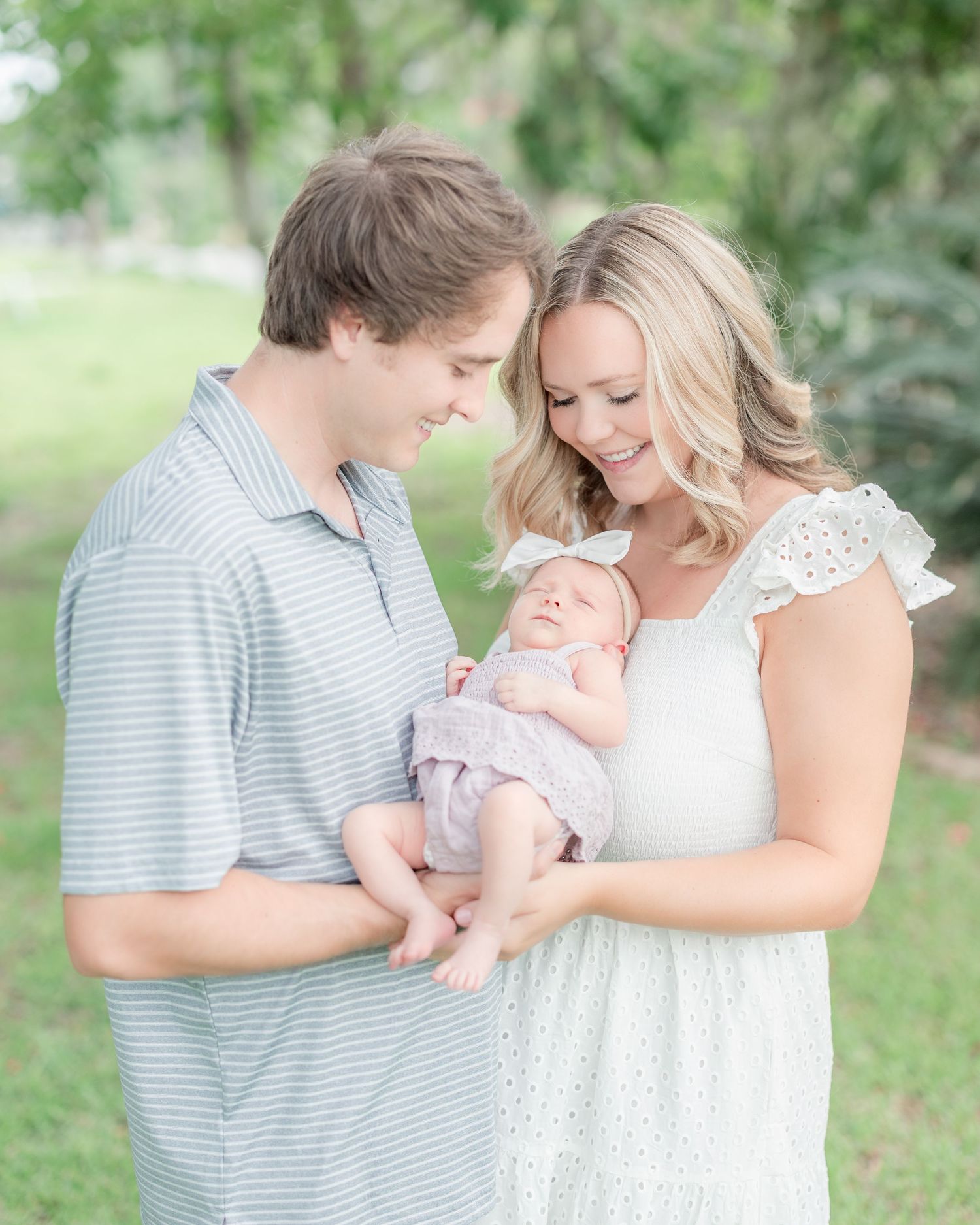 Candid, natural family portrait session featuring parents and children laughing together outdoors in South Georgia.