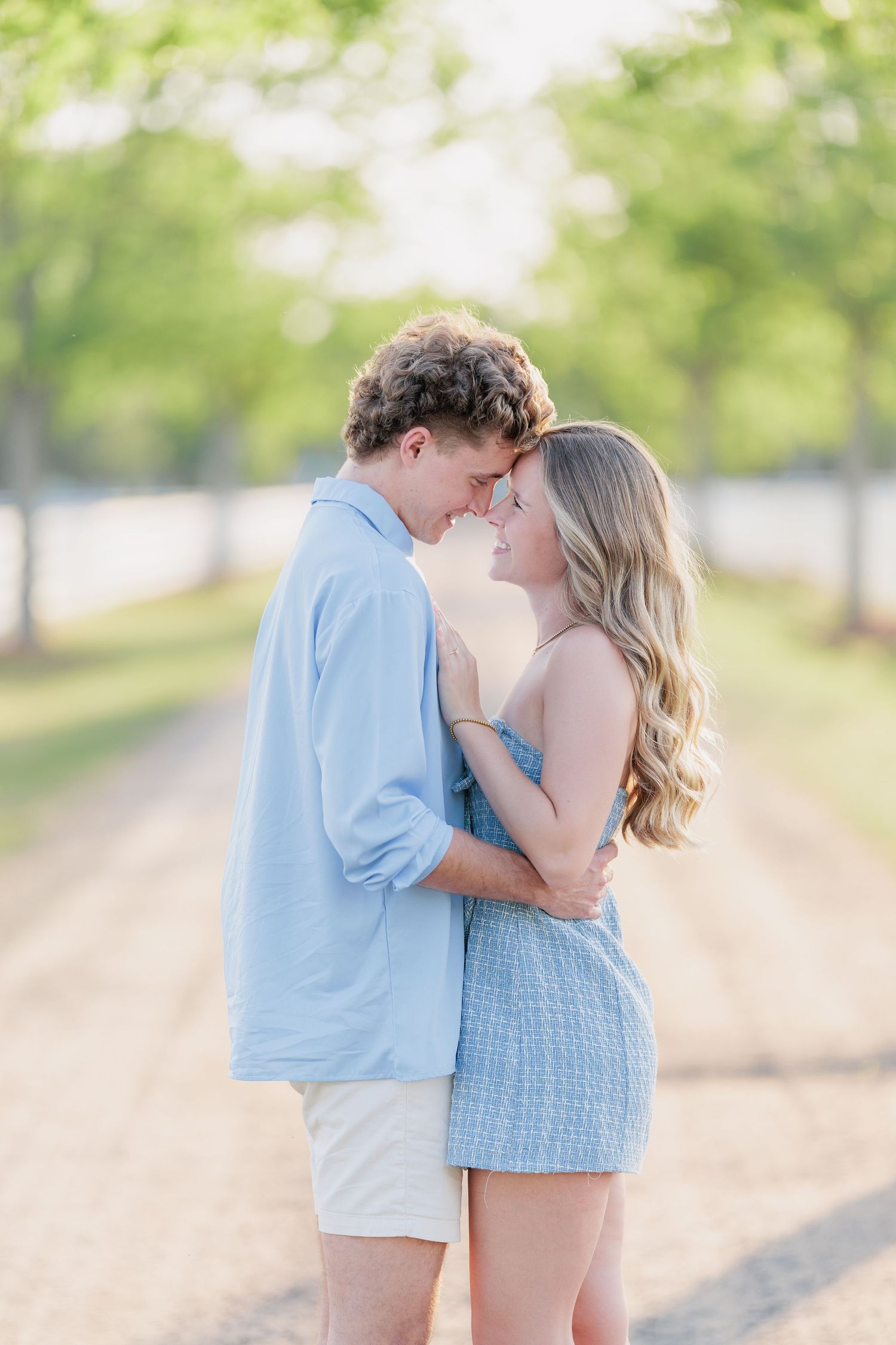 Authentic, joyful engagement portrait of a couple laughing together during a golden hour session with photographer based in Valdosta, GA.