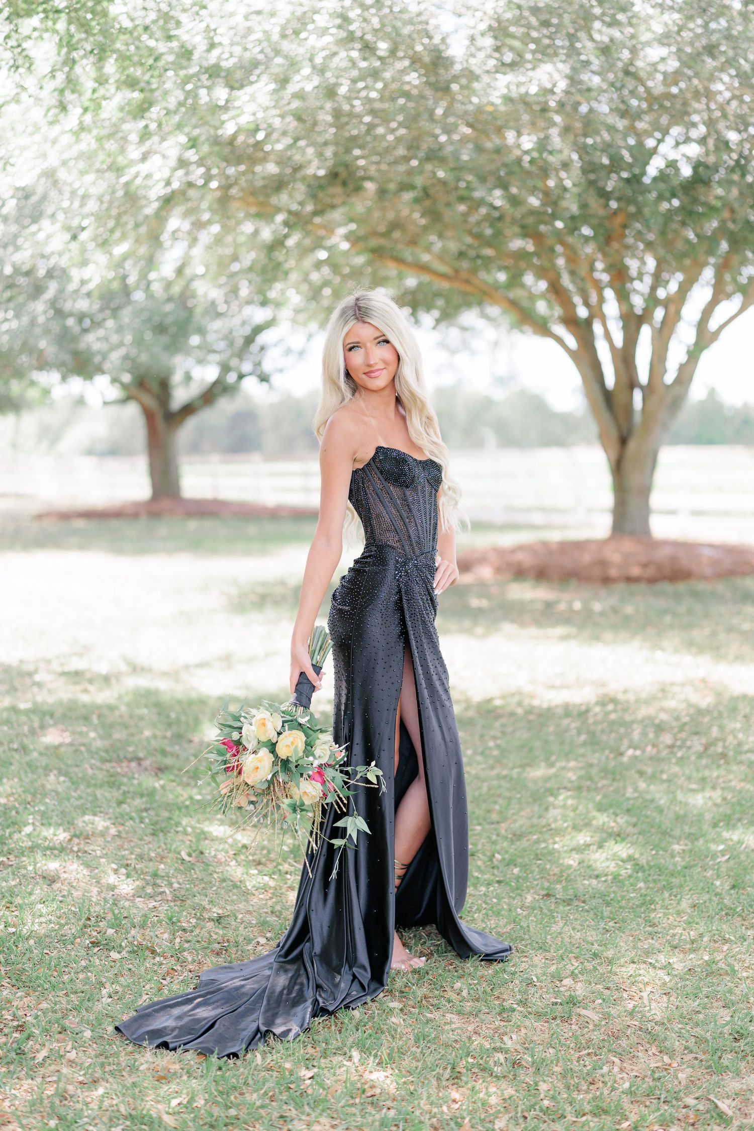 Beautiful portrait of a high school girl in her elegant prom dress holding a floral arrangement, taken by a photographer in Valdosta, GA.