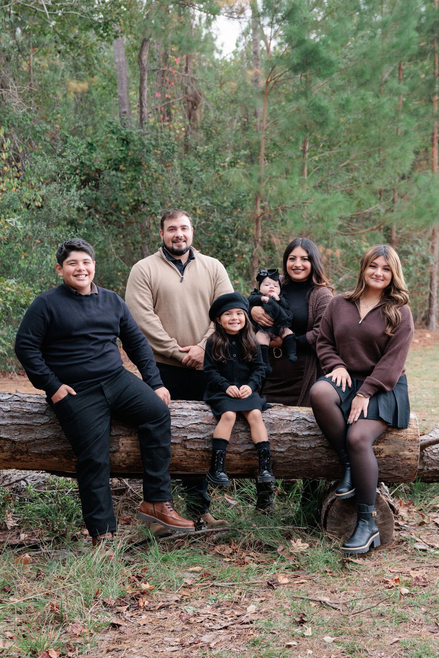 Candid, natural family portrait session featuring parents and children laughing together outdoors in South Georgia.