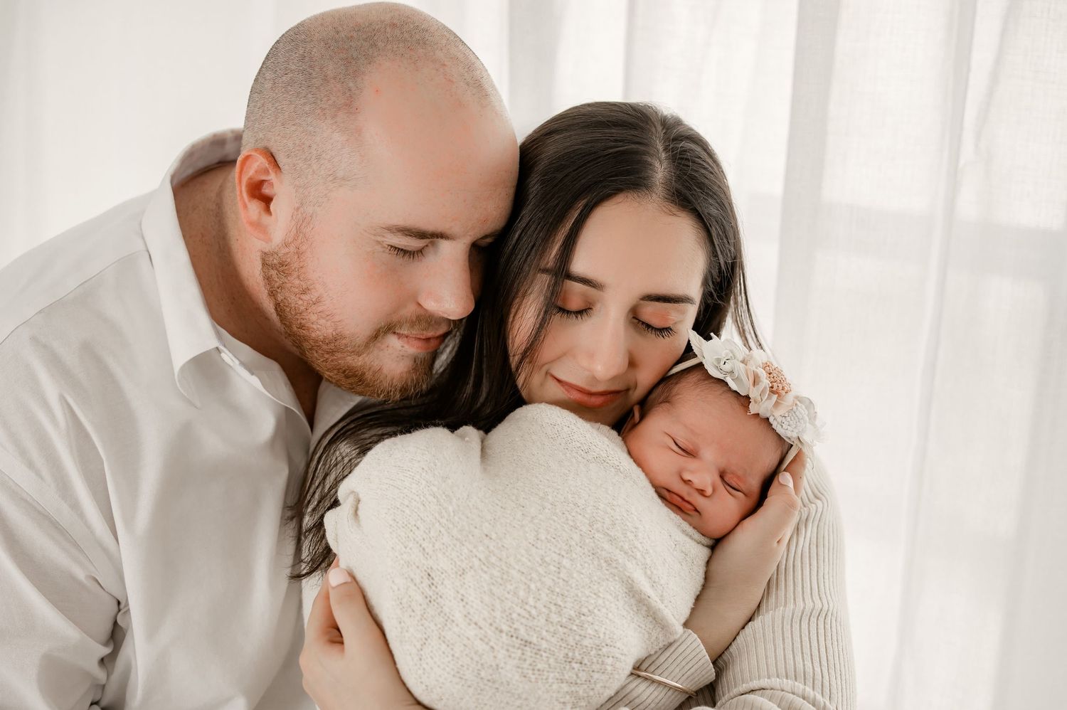 Houston family newborn photography session with parent holding sleeping baby.