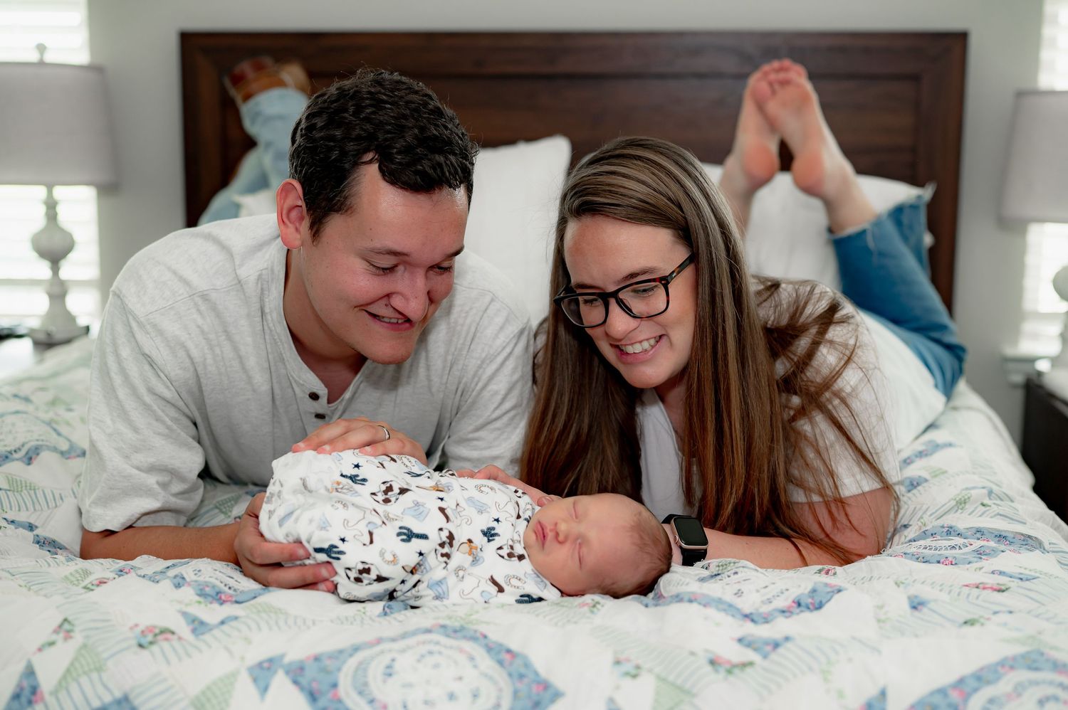 Parent with newborn baby during a lifestyle in- home newborn session in Katy Tx