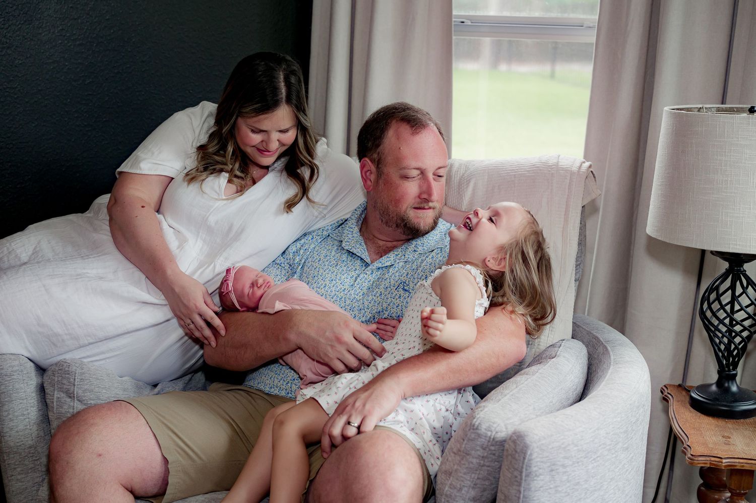 Candid family moment during an in-home newborn session in Houston, TX.
