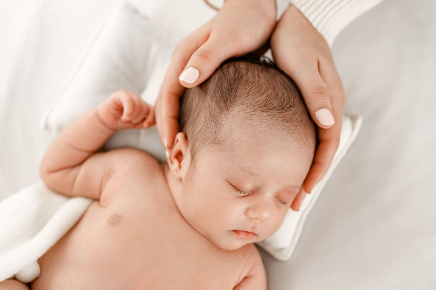 Newborn in the safety of moms hands Fulshear TX studio session