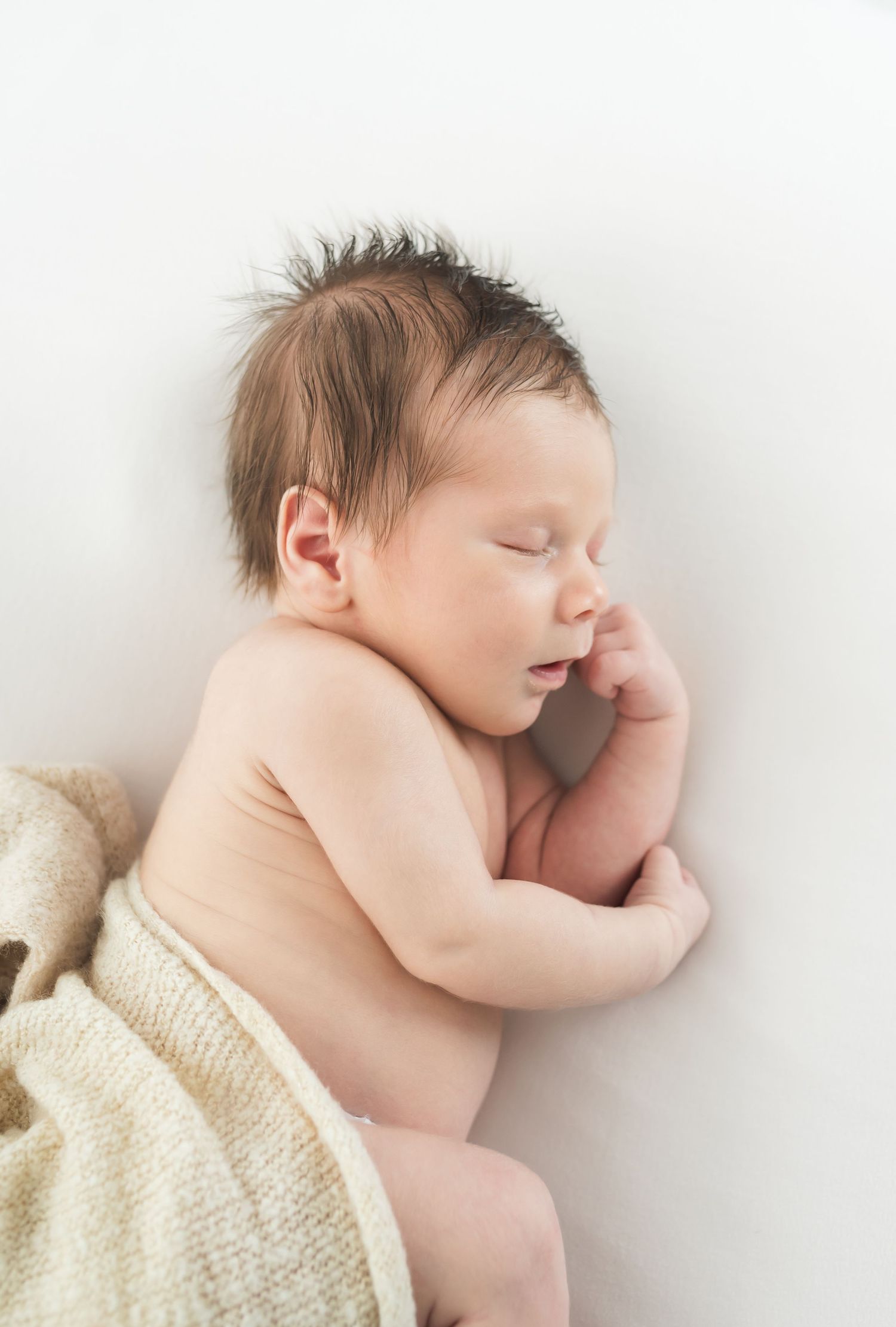 Newborn baby sleeping  during newborn session in Fulshear TX