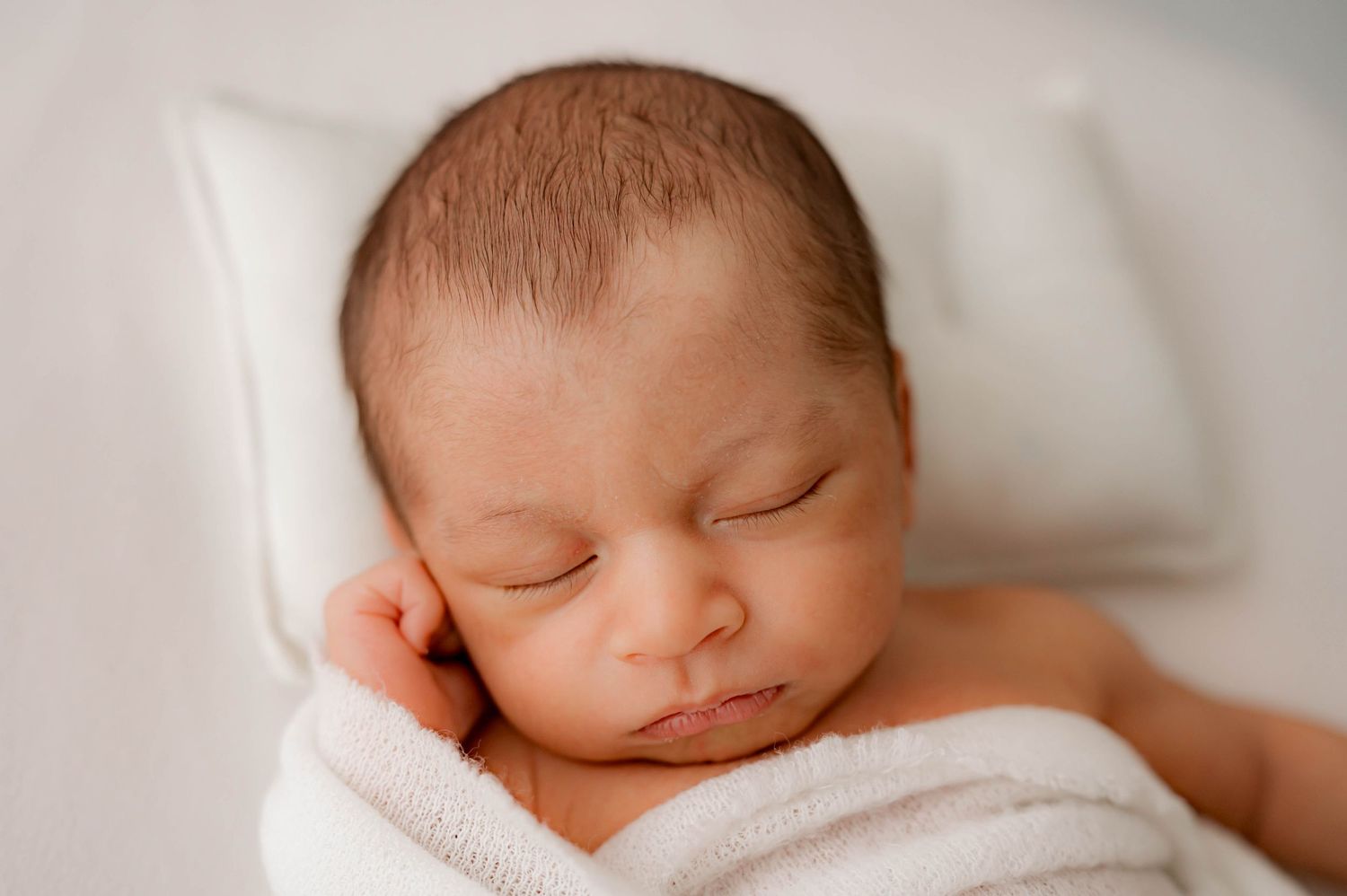 Close up of sleeping newborn baby during his newborn photo session in Katy, TX.