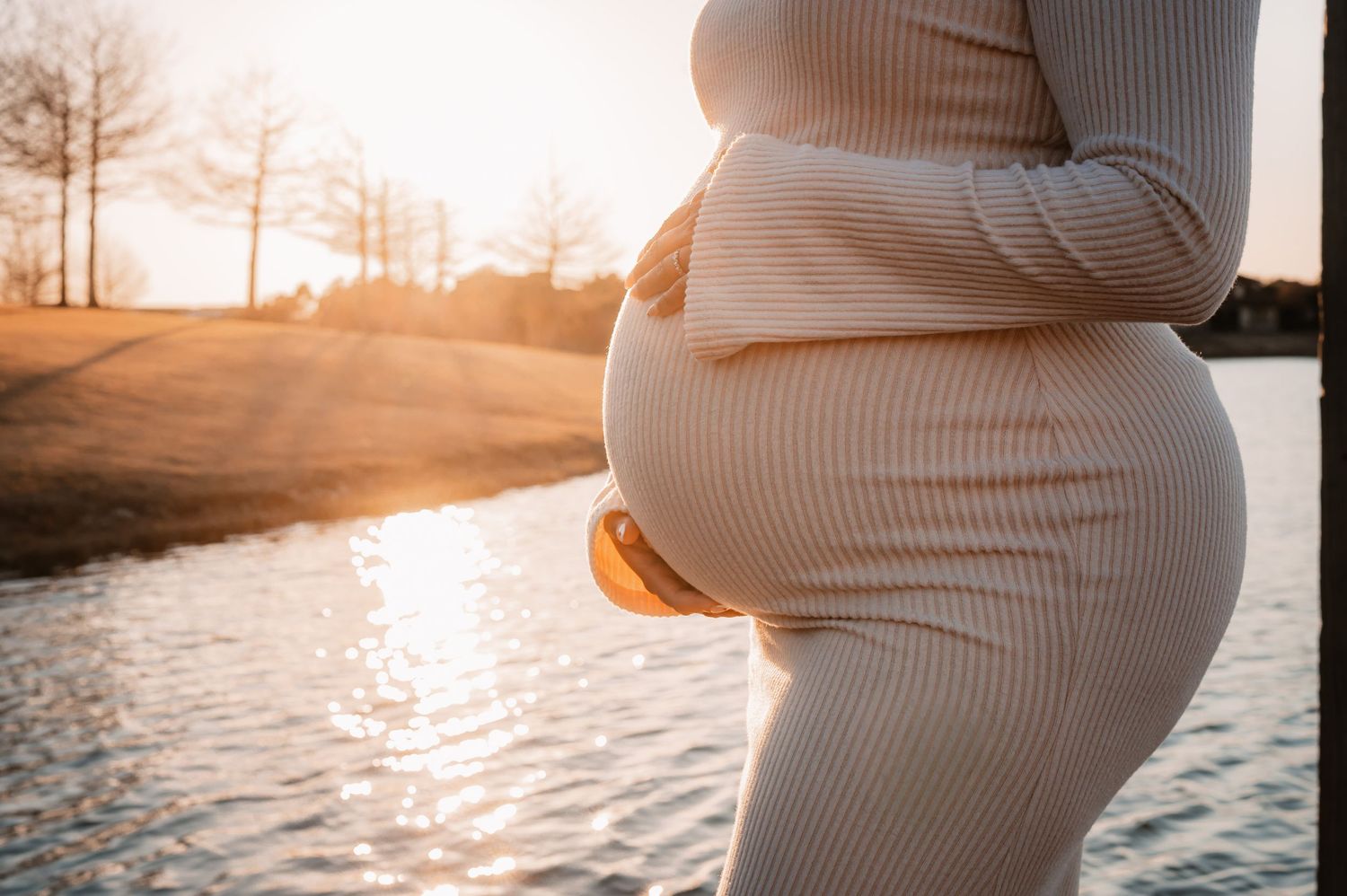 Baby bump close up during a sunset maternity session in Fulshear, TX.