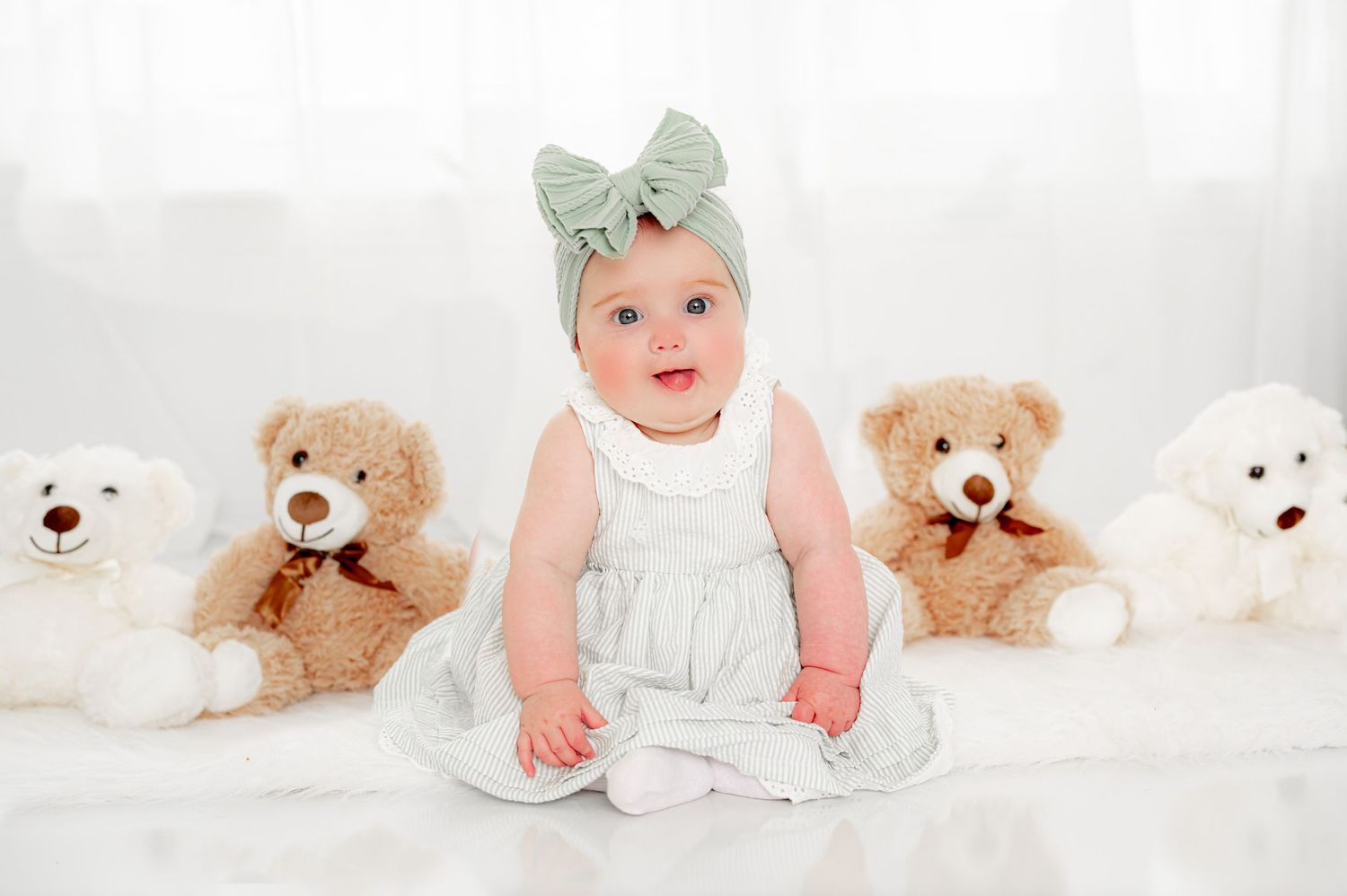 6 month milestone sitter session with baby girl in neutral studio setup and teddy bears in Houston, TX.