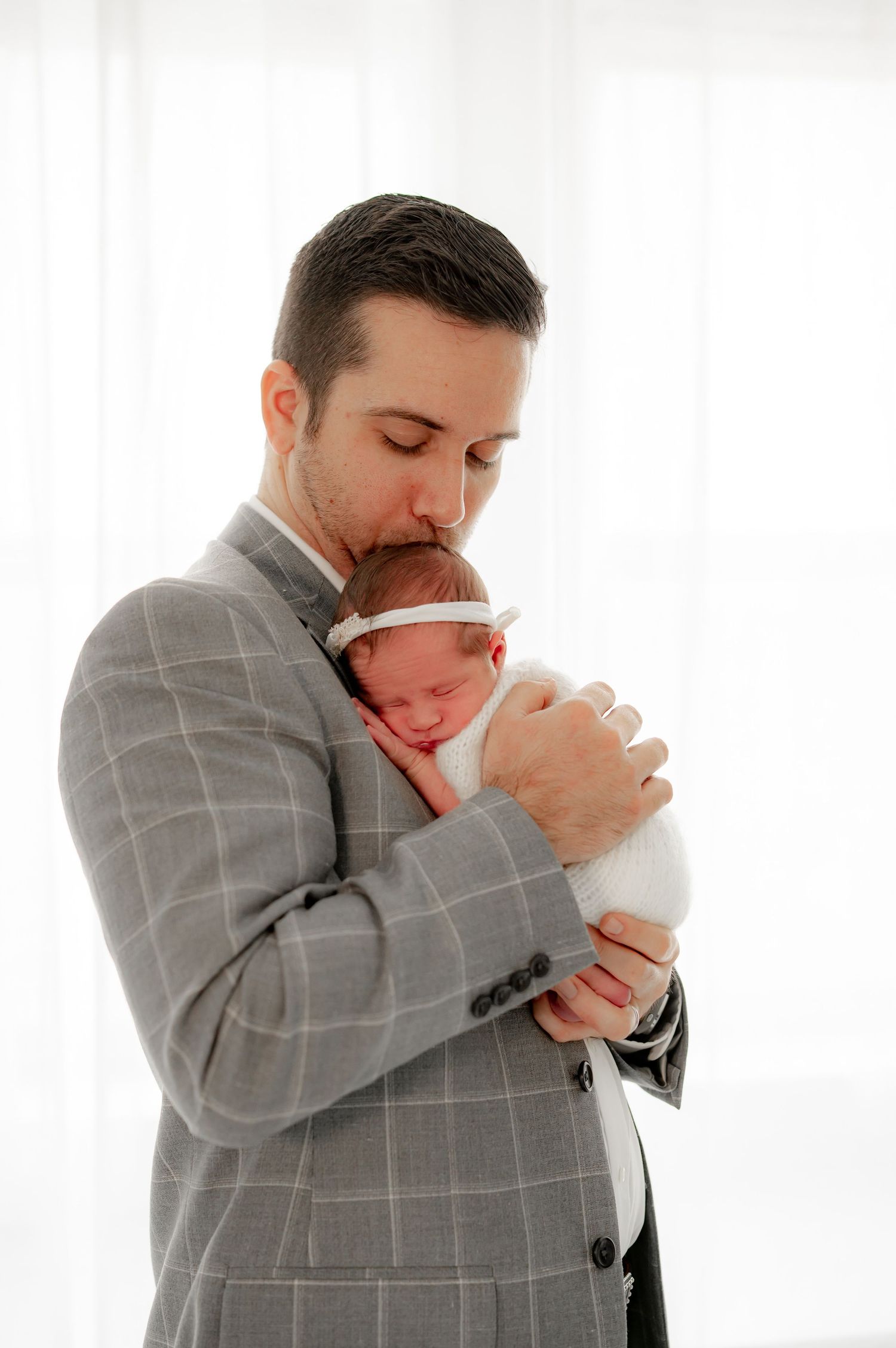 Dad snuggling baby in studio Fulshear session