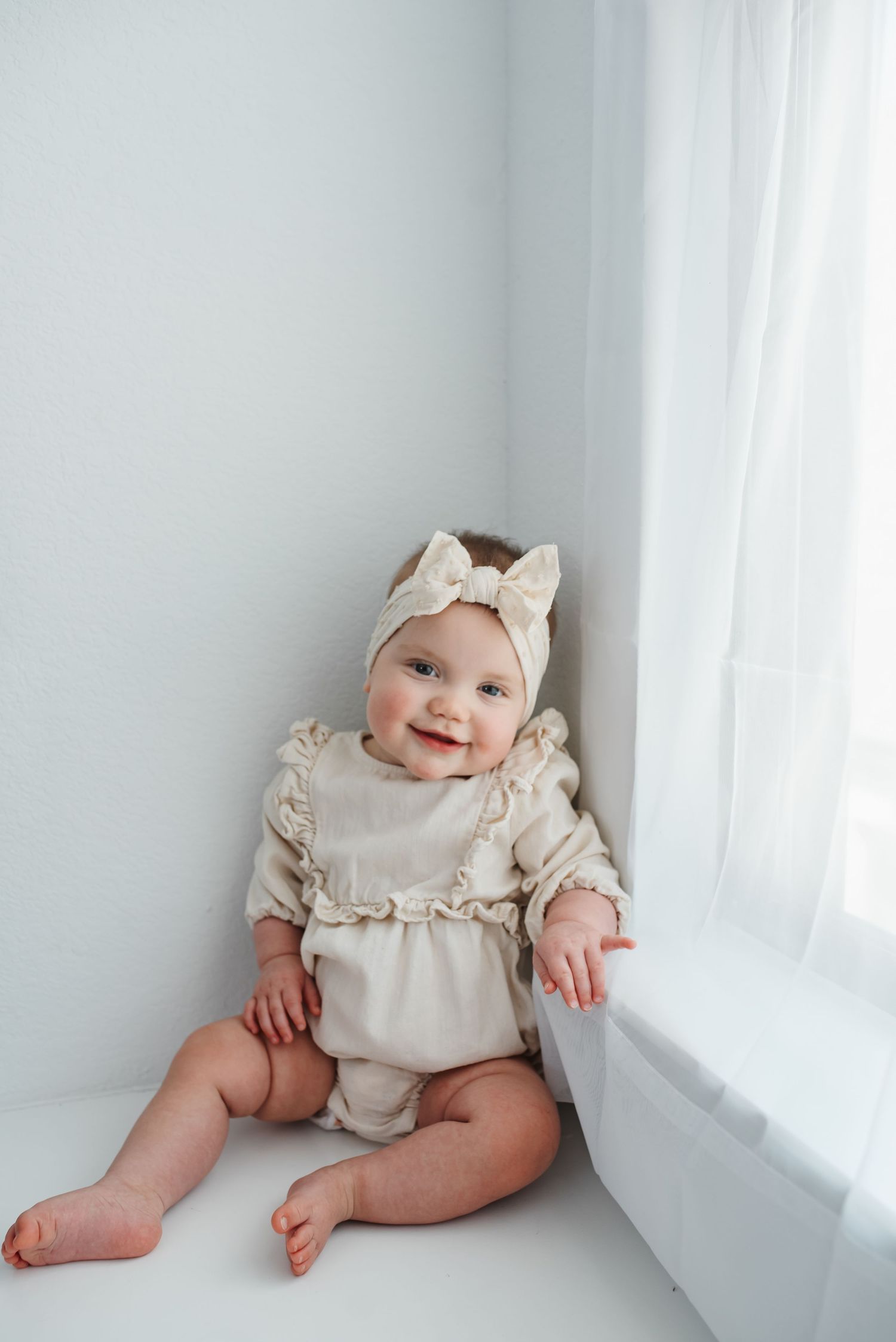 Smiling baby during milestone photography session in Katy, TX studio.