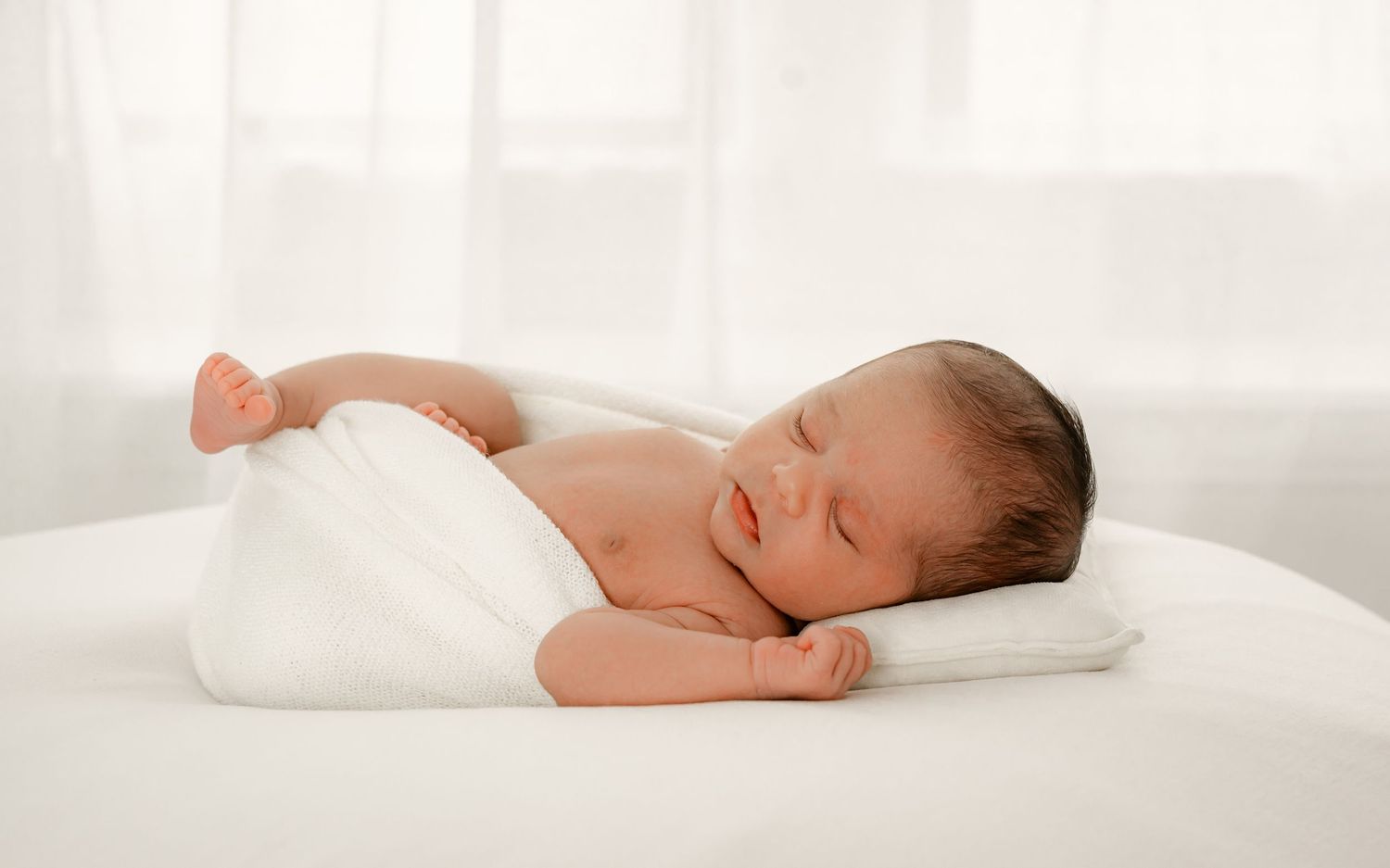 Sleeping newborn baby during a baby-led studio session in Fulshear studio session