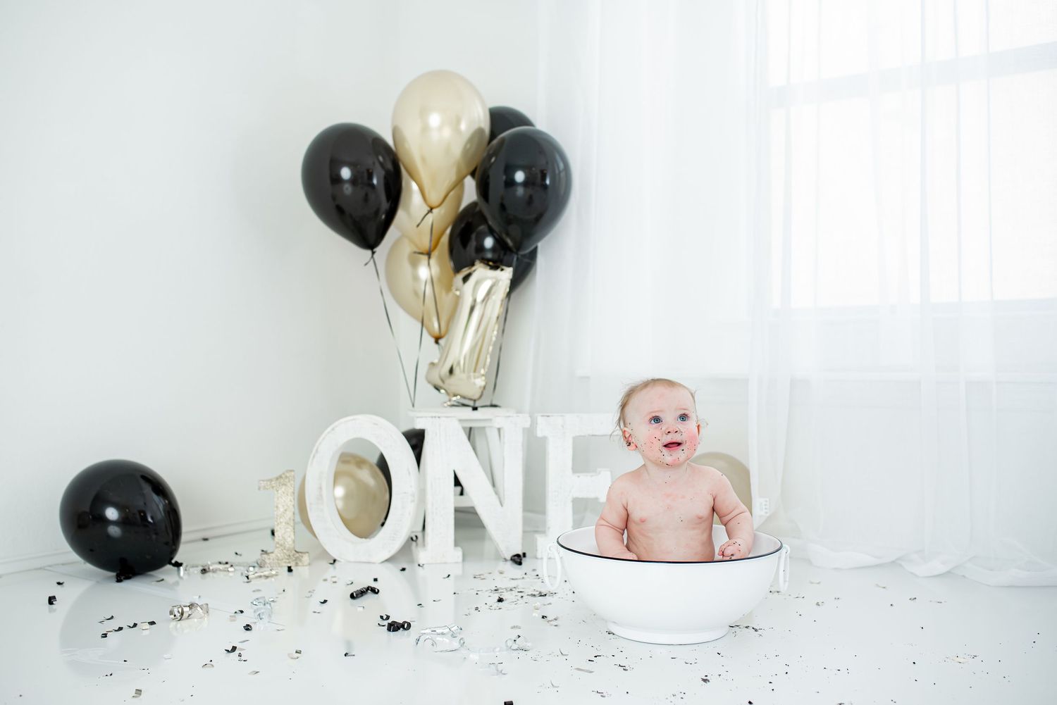 Baby boy splash session after cake smash in ONE year birthday set up in Houston, TX.