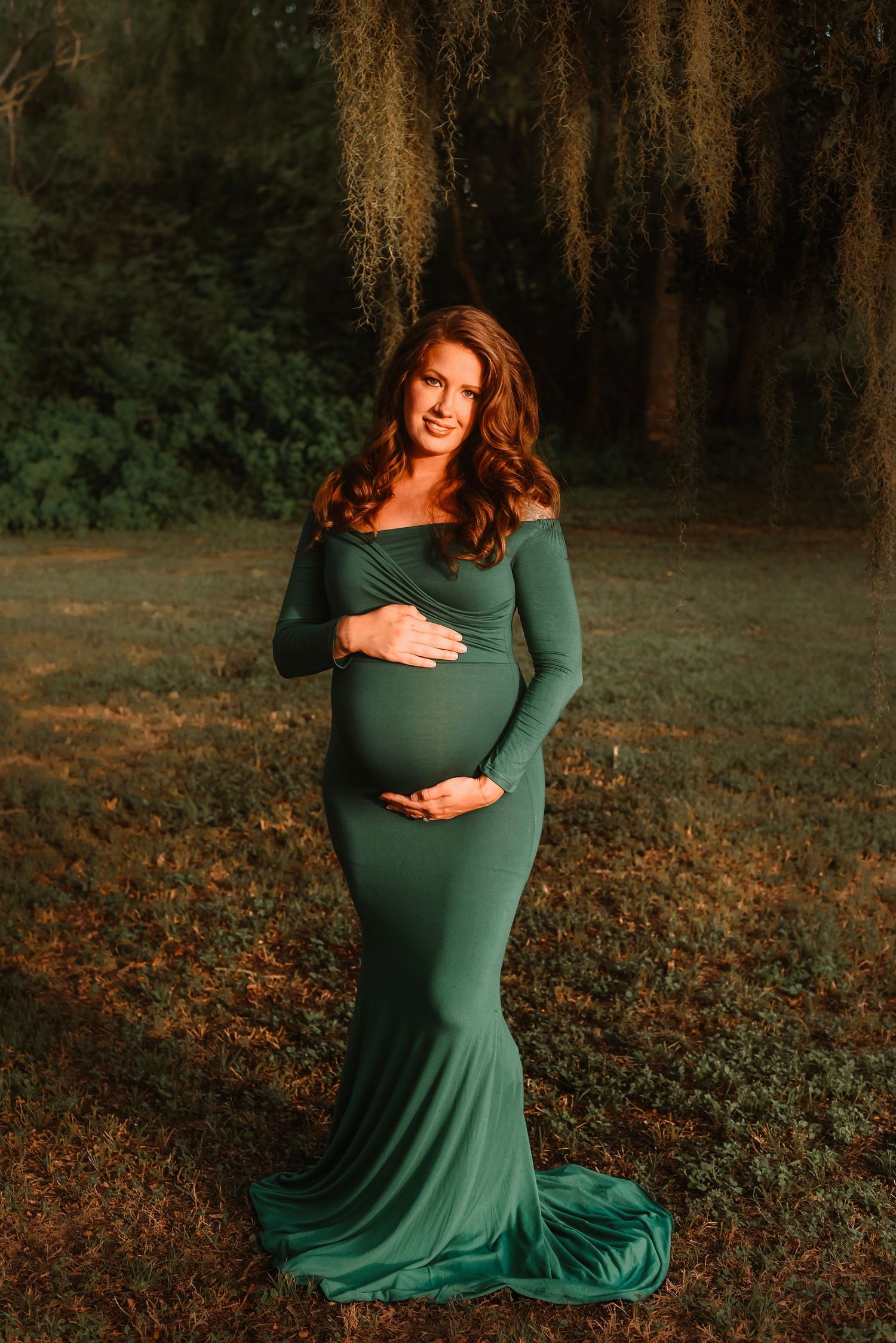 Outdoor maternity session of expectant mother holding her bump in Katy.