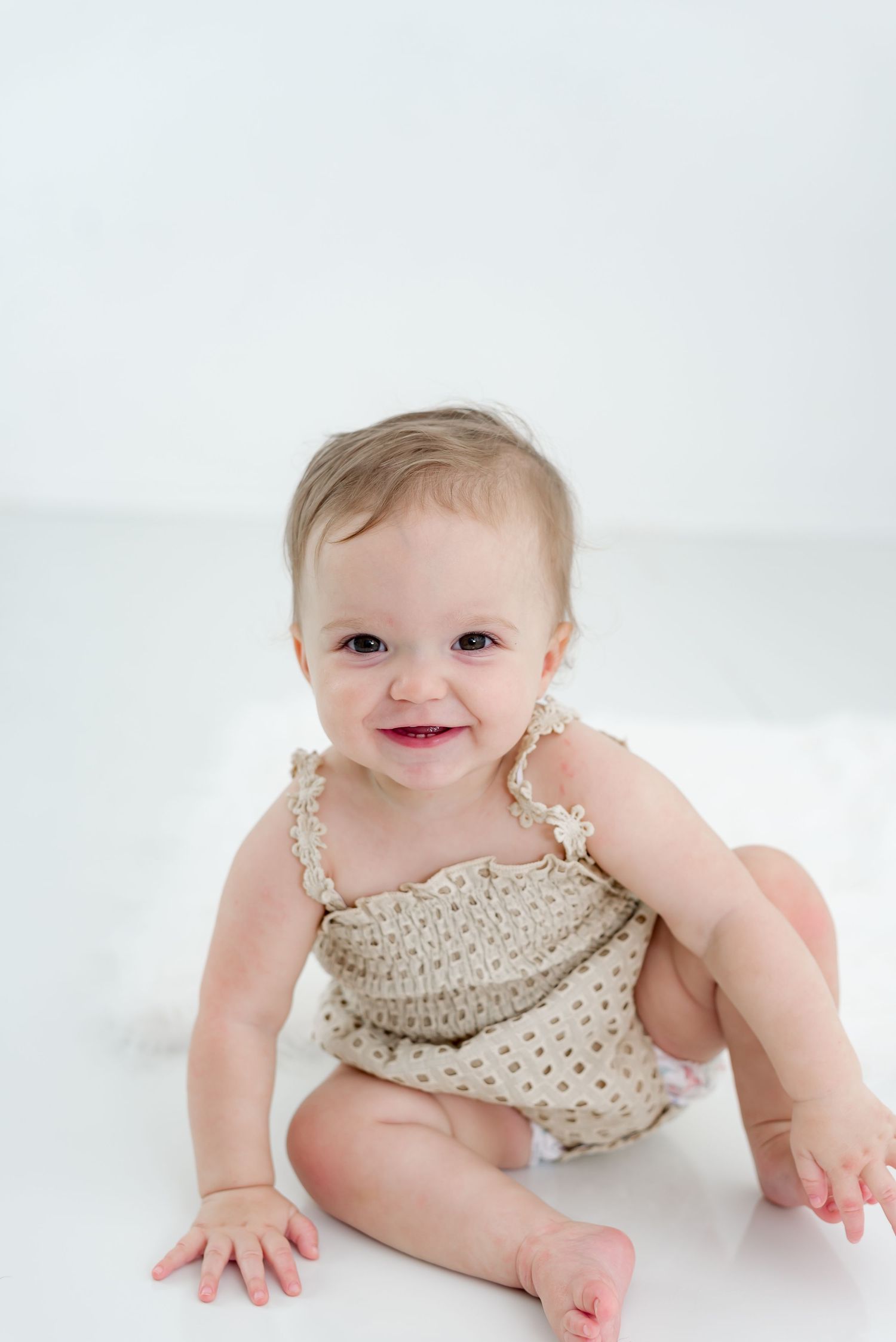 9 month baby milestone photography session with standing and crawling portraits.