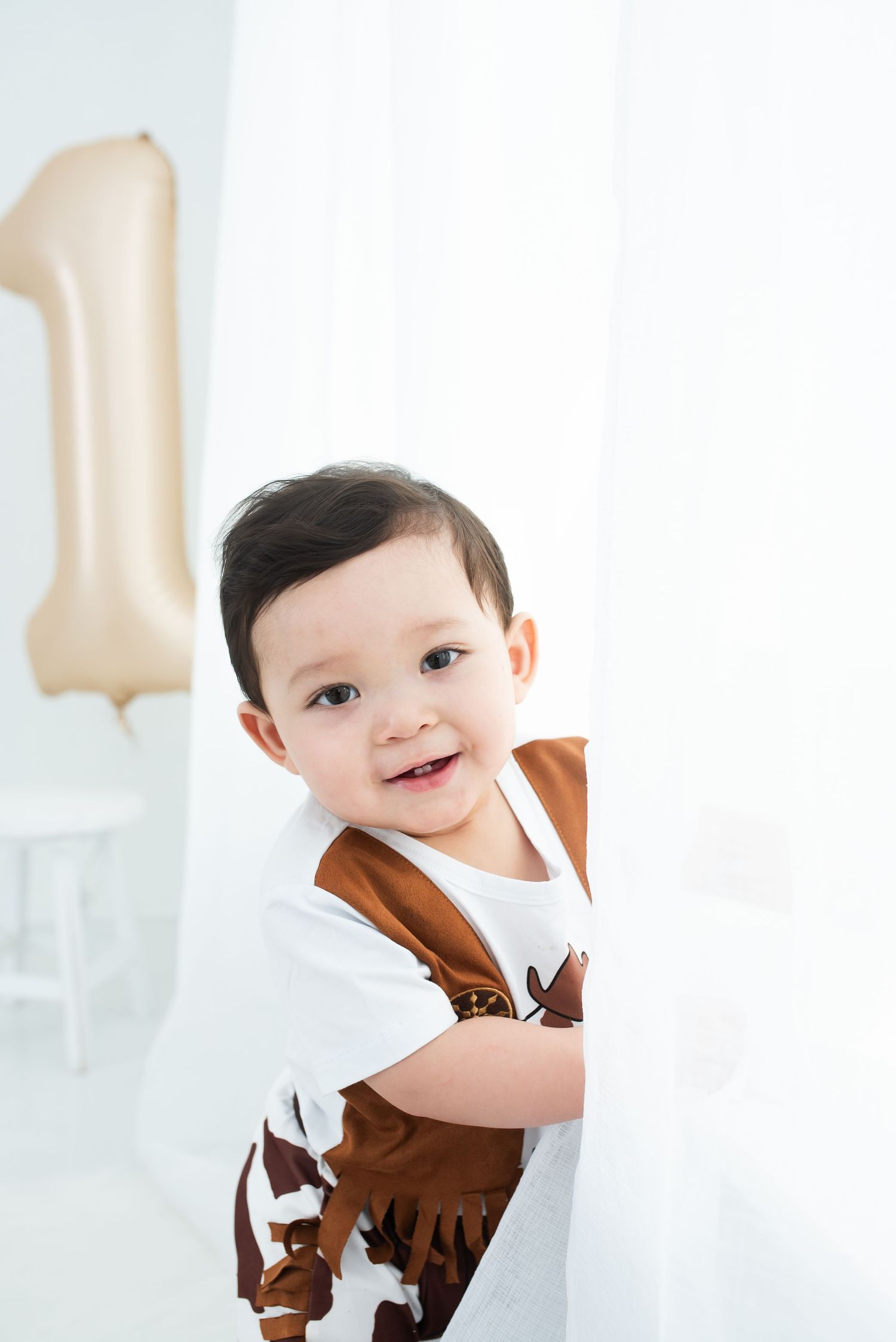 Smiling baby during his cowboy themed milestone studio session