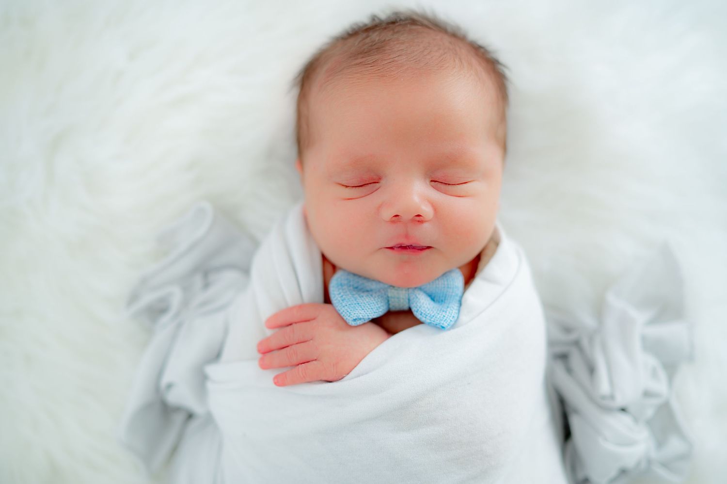 Wrapped sleeping newborn during Fulshear, TX studio session.
