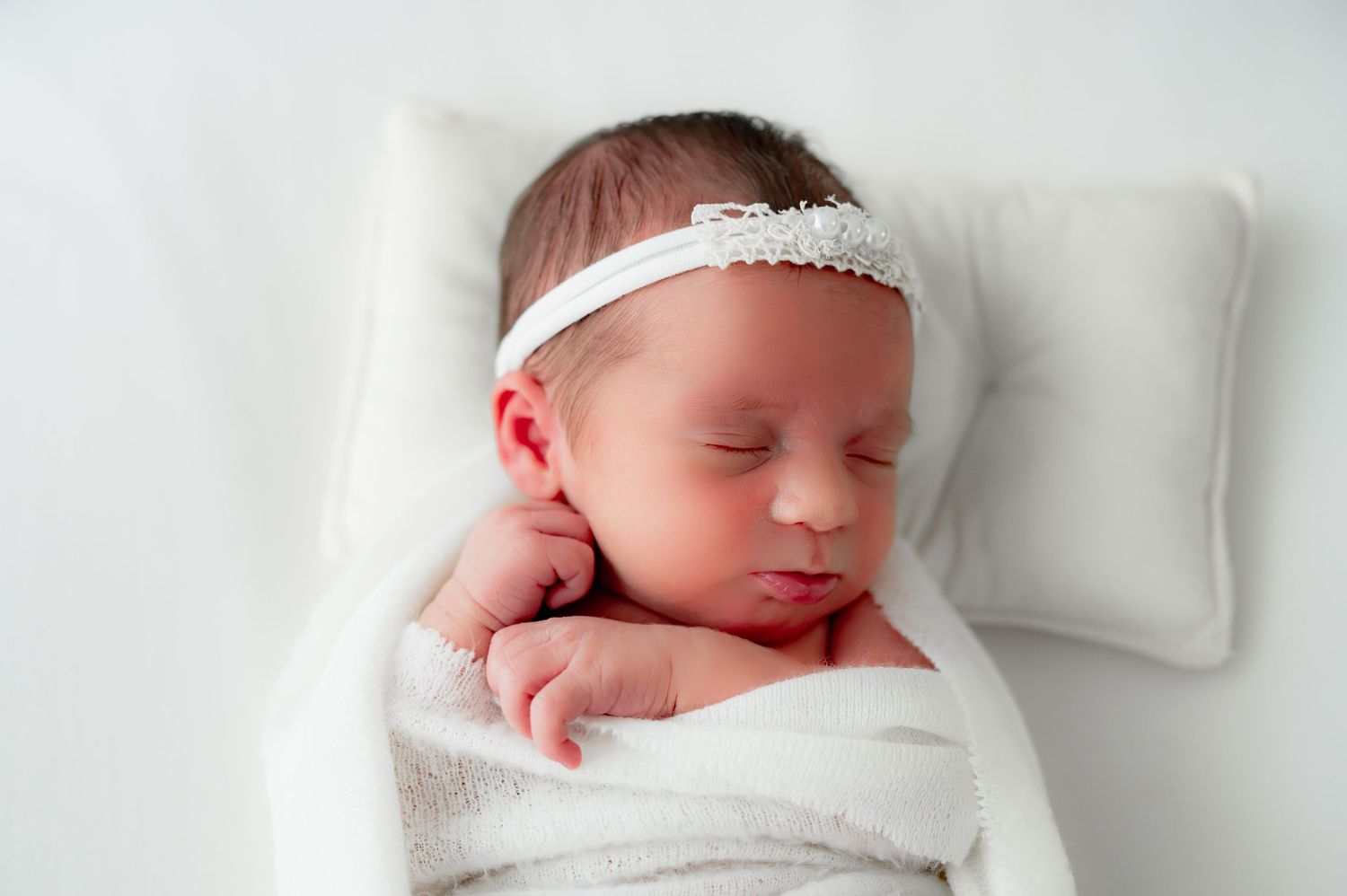 Pouty lip baby during a relaxed newborn session in Fulshear studio session.