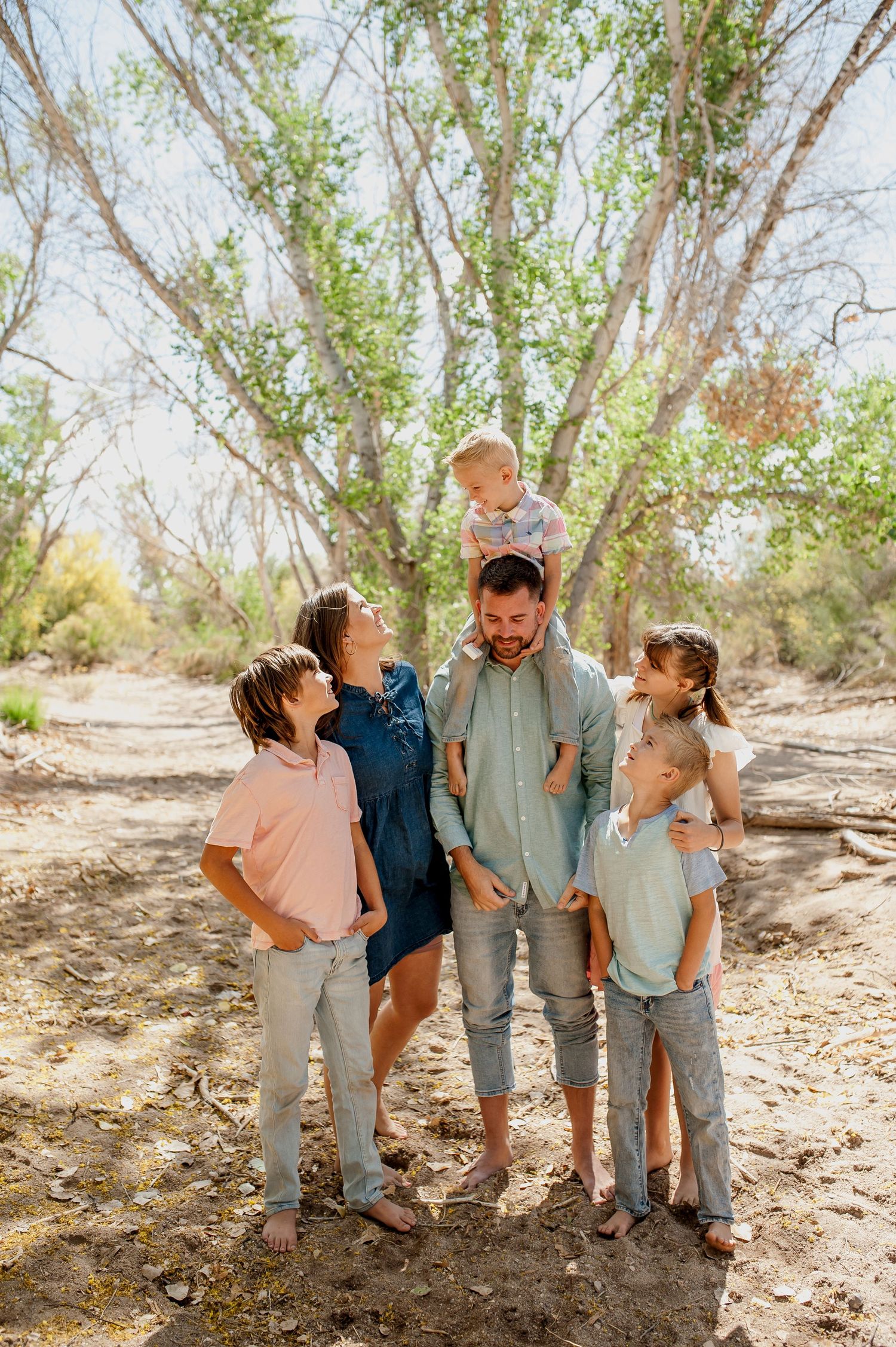 Family photographer playing candidly with children in queen creek arizona