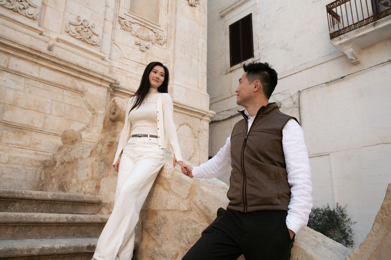 A romantic proposal scene unfolds against historic architecture.